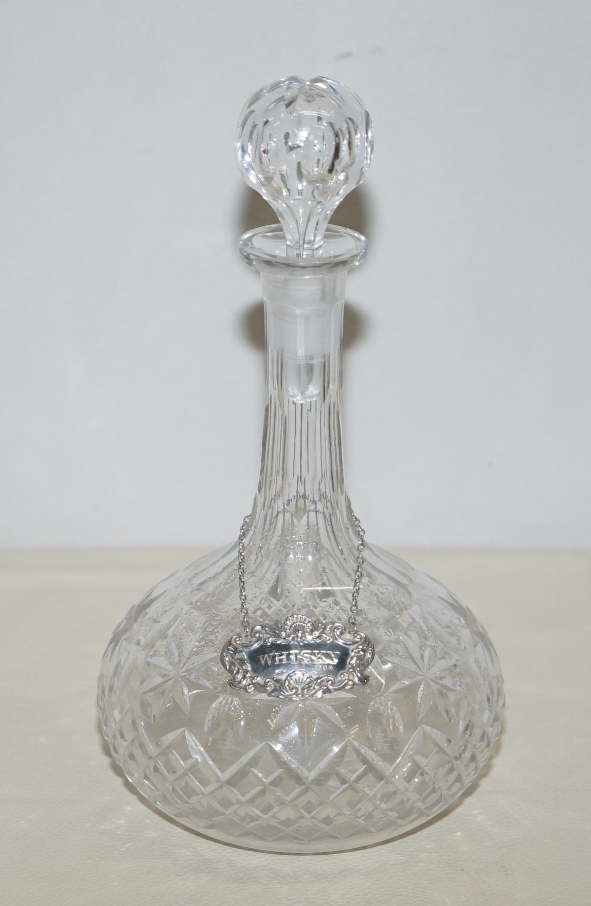 We are delighted to this sublime cut glass crystal decanter with sterling silver Whisky hanging label

A good looking and decorative piece, the hanging collar is clearly hallmarked with the sideways facing lion for 925 sterling silver, the