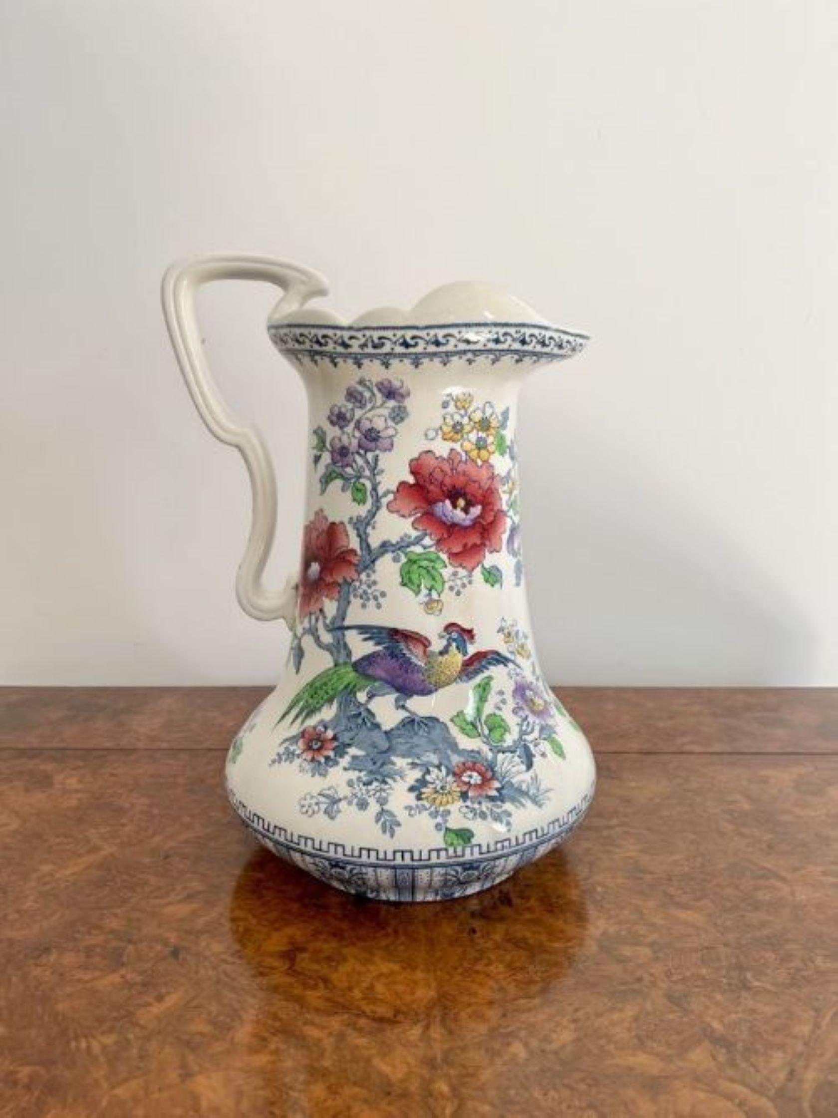 Lovely antique Edwardian jug and bowl set having a lovely antique Edwardian jug and bowl set decorated with flowers, leaves and birds in blue, red, yellow and green colours on a white background. 