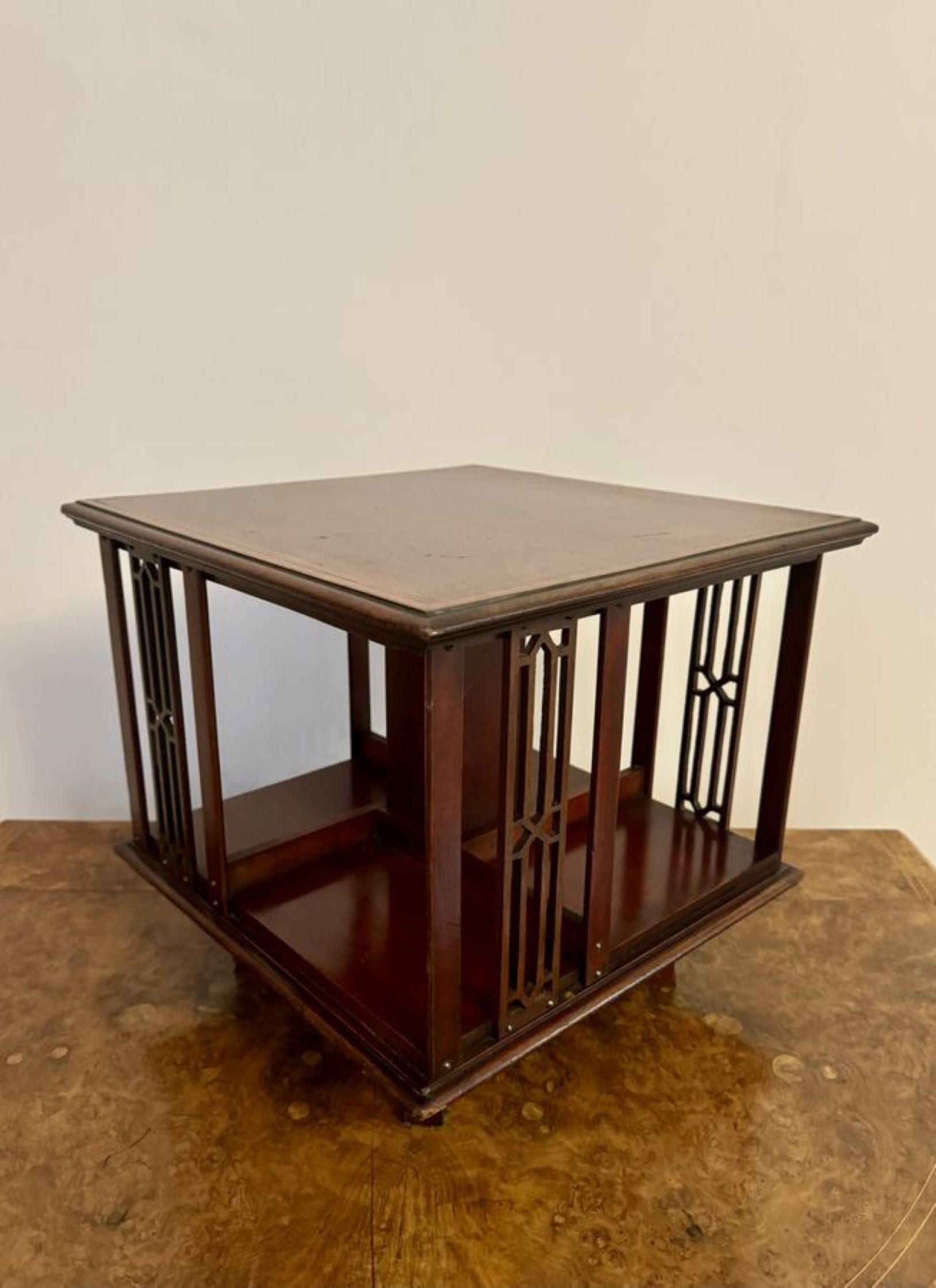 Lovely antique Edwardian mahogany table top revolving bookcase, having a rectangular shaped inlaid top with pierced slatted sides.

D. 1900