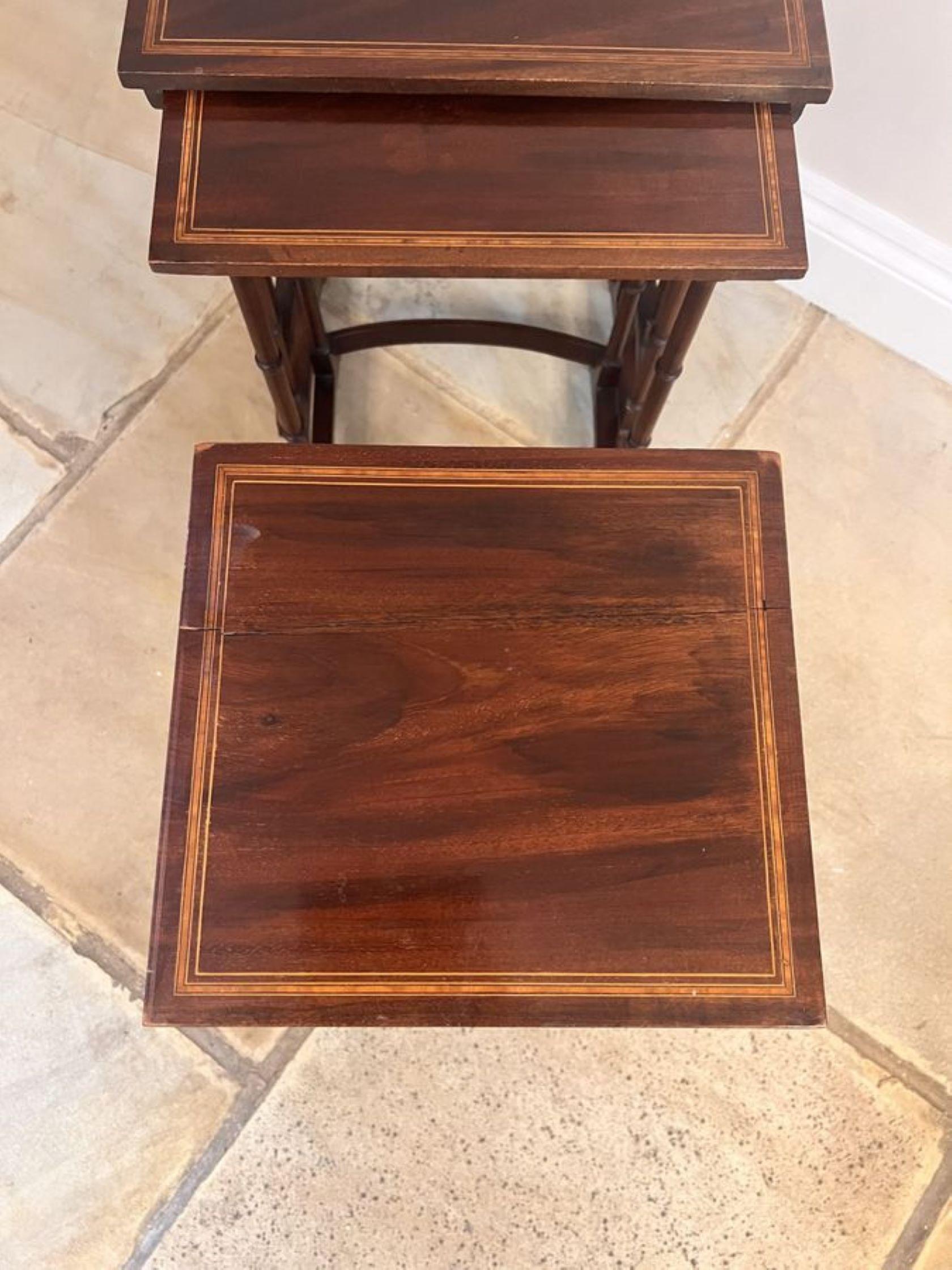 Lovely antique Edwardian mahogany nest of four tables, having a quality nest of four mahogany and satin wood cross banded occasional tables supported by turned columns standing on shaped feet united by a mahogany stretcher.

D. 1900