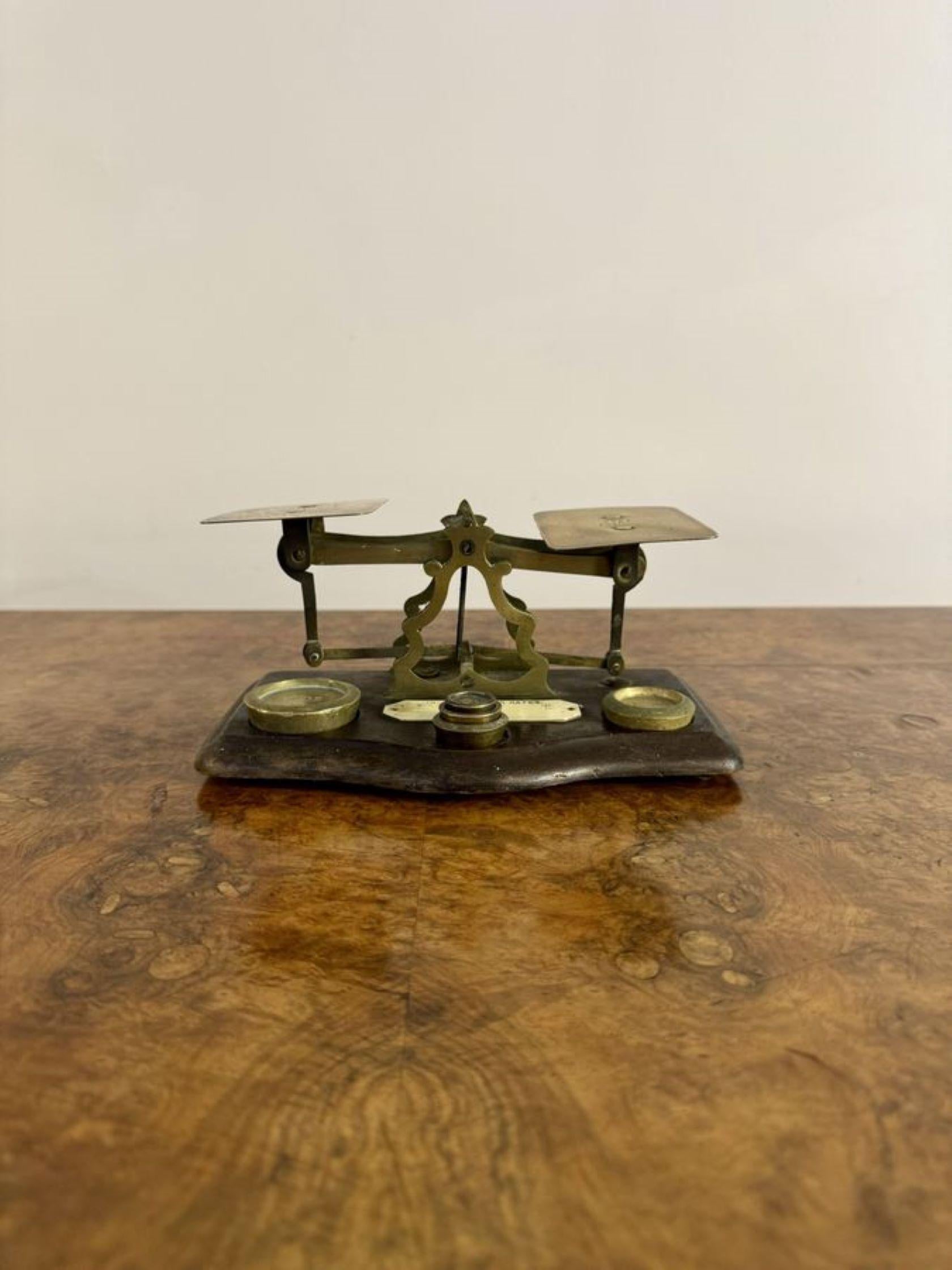 Lovely antique Edwardian postal scales & weights, having a lovely pair of antique Edwardian brass postal scales with brass weights mounted on a wooden shaped base.

D. 1900