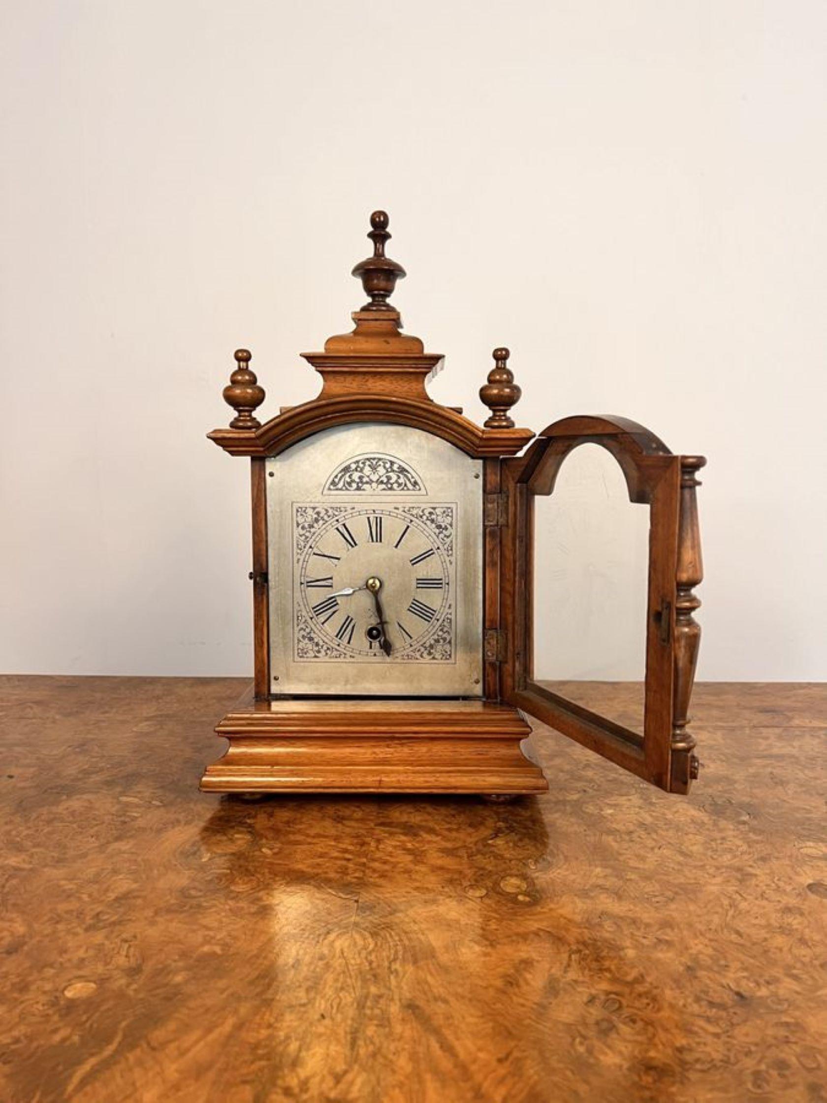 Lovely antique German Black Forest mantle clock, having a quality walnut case with turned columns shaped top with the original finales, standing on a stepped base, silvered arched engraved dial with Roman numerals and the original hands having an