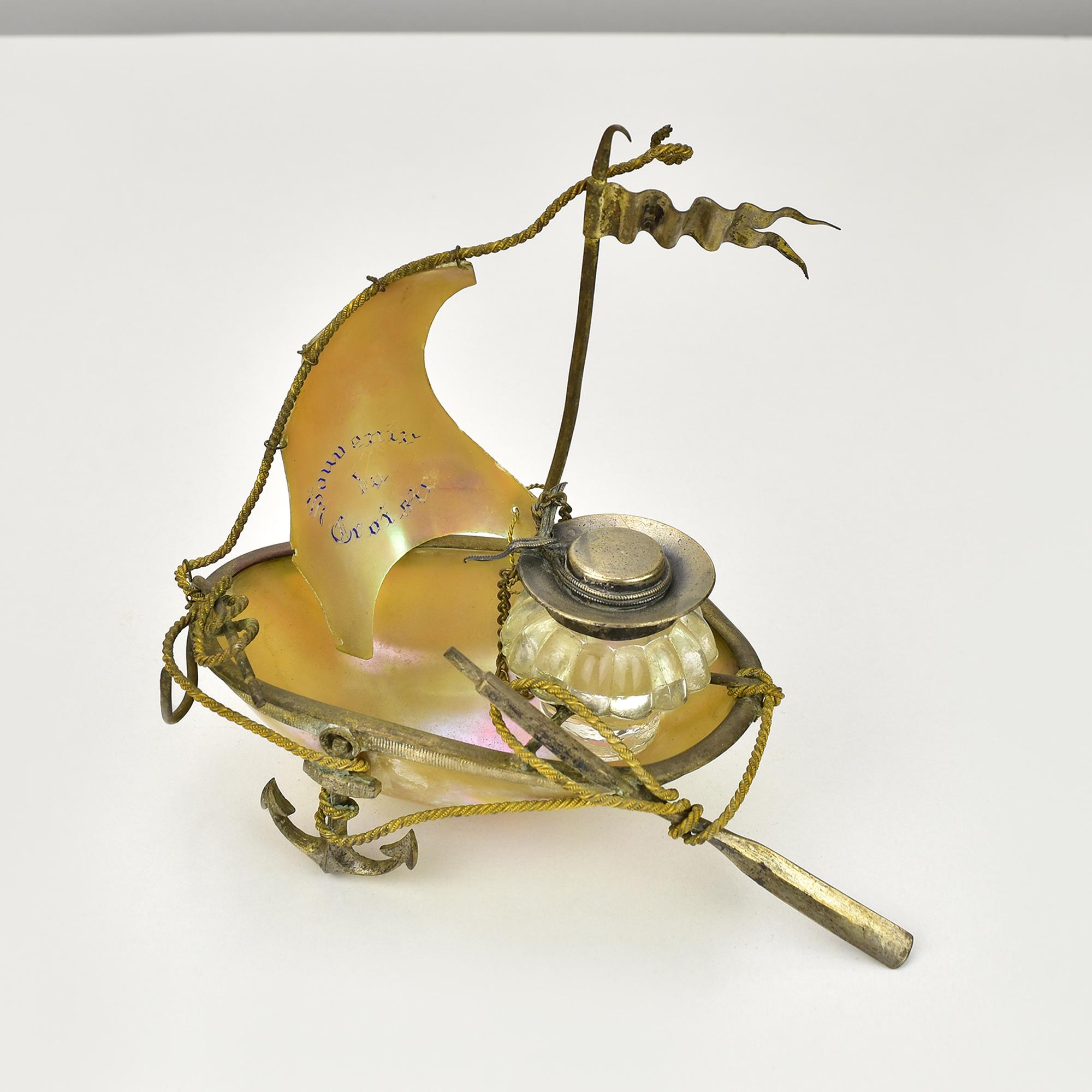 This exquisite antique inkwell is a stunning example of Art Nouveau design, shaped like a grotto shell and inscribed with 