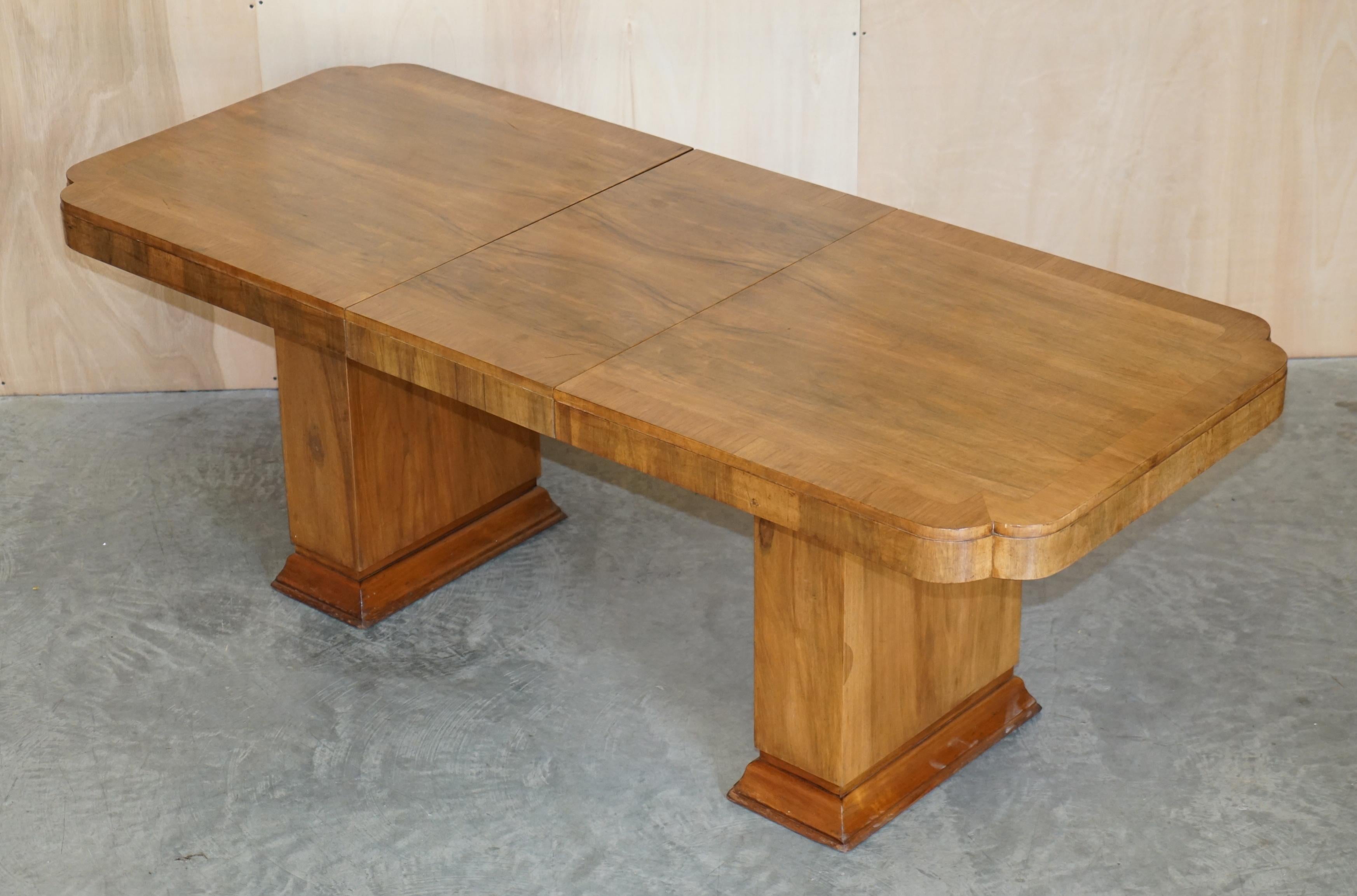 We are delighted to offer for sale this lovely circa 1920’s Art Deco walnut extending dining table.

A very good looking and expertly crafted table, it has hidden inside the frame one large extension leaf which adds another 45cm to the depth which