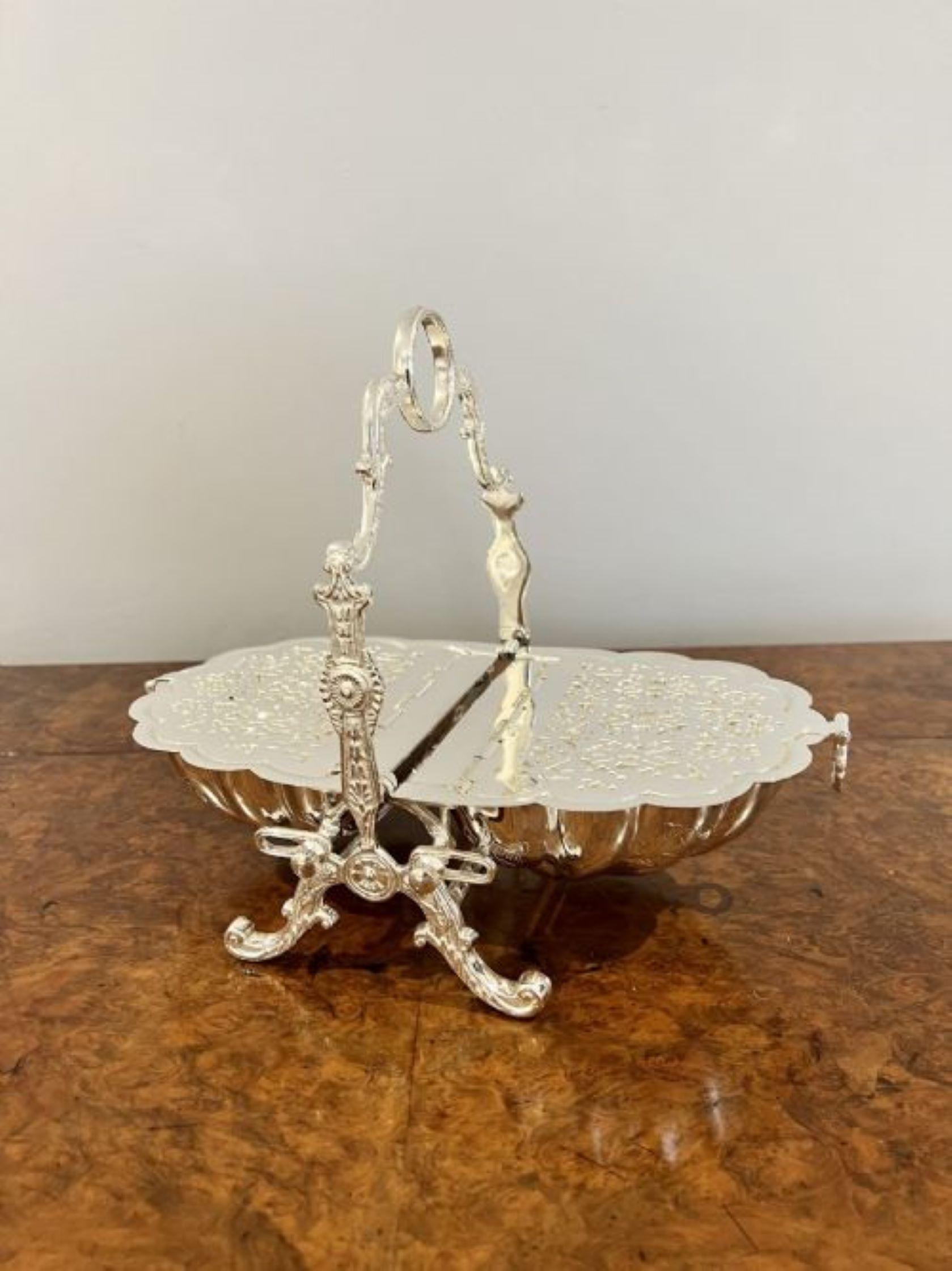 Lovely antique silver plated biscuit box having a lovely antique silver plated biscuit box with a carrying handle to the top, two lift up covers to the sides, lovely ornate detail standing on ornate shaped feet.