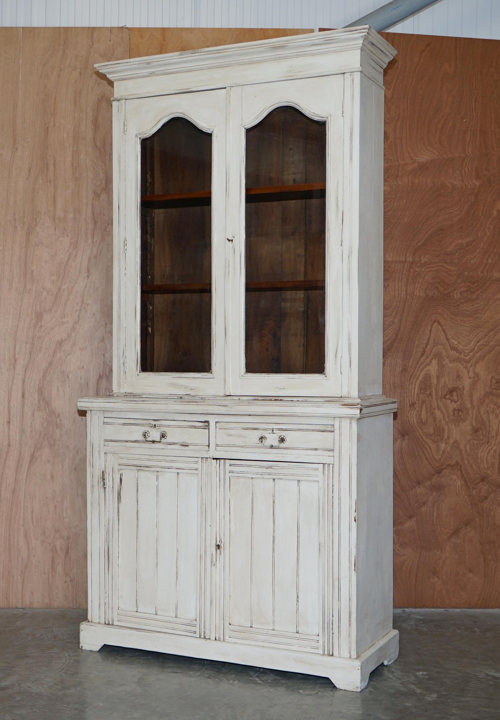 We are delighted to offer this very well made solid mahogany hand painted cupboard with library bookcase top

A very well made circa 1880 piece of English country house furniture. This can be used as a kitchen pot cupboard or as a library bookcase