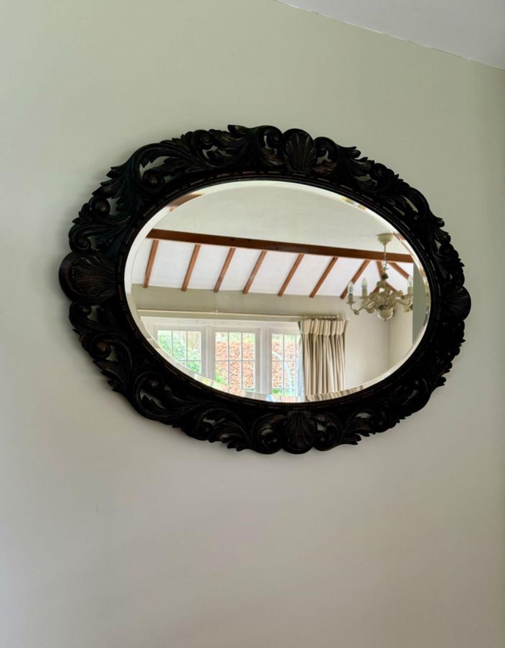 Lovely antique Victorian quality carved oak wall mirror, having the original bevelled edge mirror in a quality carved oak oval frame with leaves, shells and scroll carving.

D. 1880