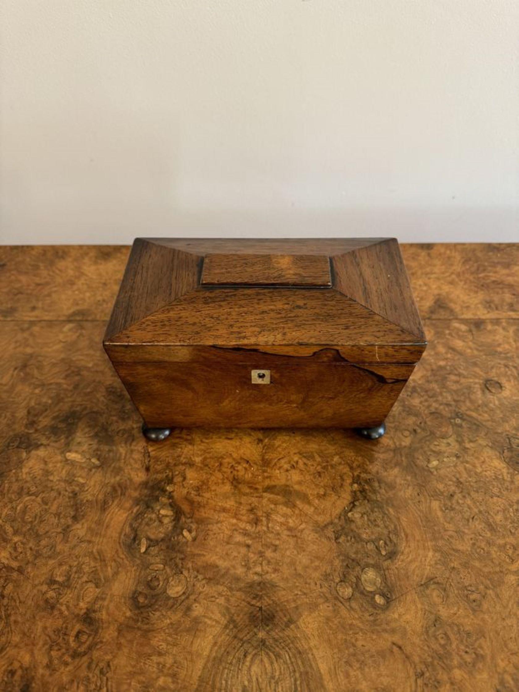Lovely antique Victorian rosewood tea caddy, having a quality rosewood tea caddy with a lift up lid opening to reveal two compartments with removable lids for tea, raised on the original bun feet.

D. 1880