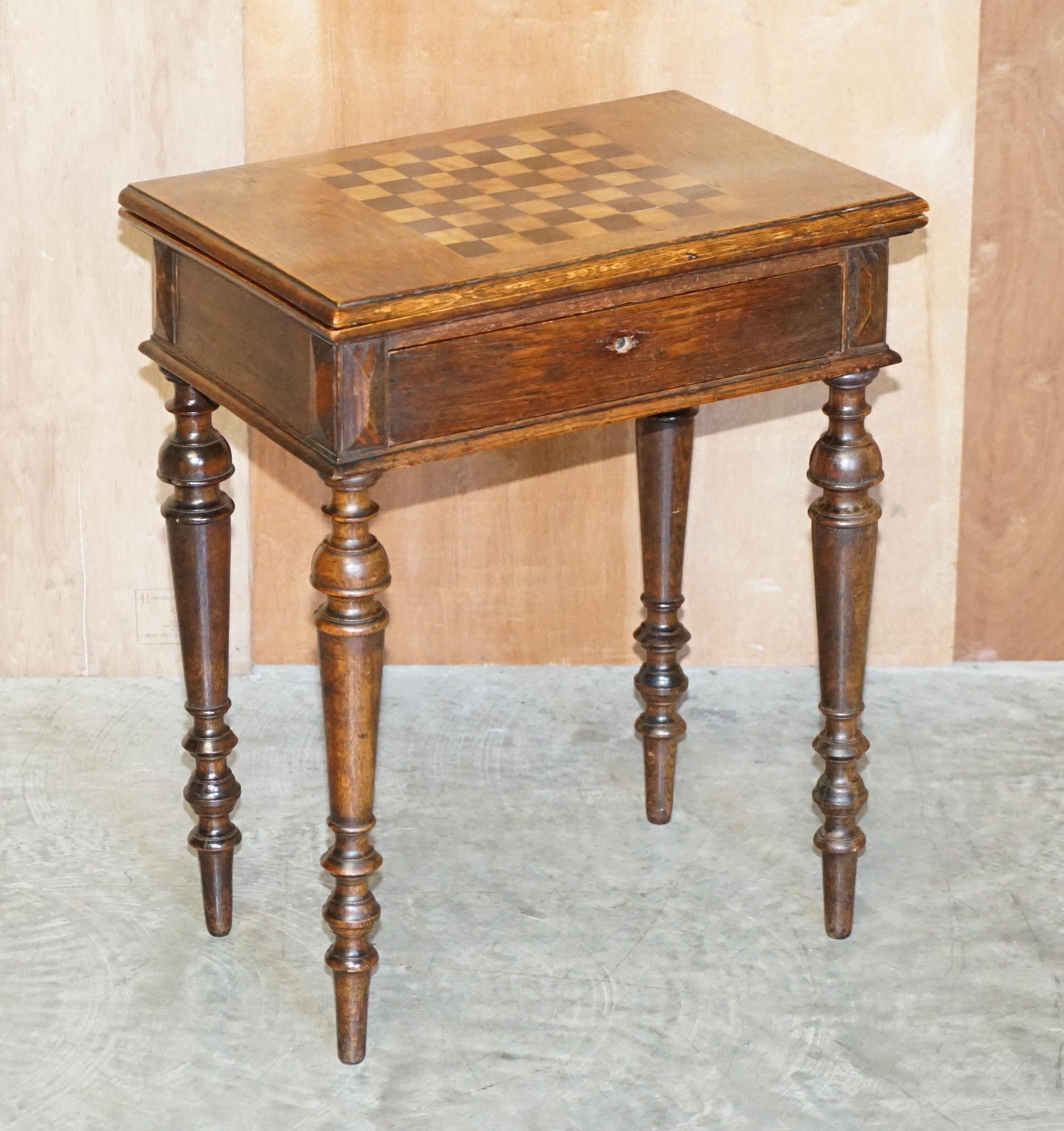 We are delighted to offer this very nice antique Victorian English oak chess table with fold over card table top

A good looking and well made piece, as you can see the main top is for chess or checkers, you have a fold over top which has the