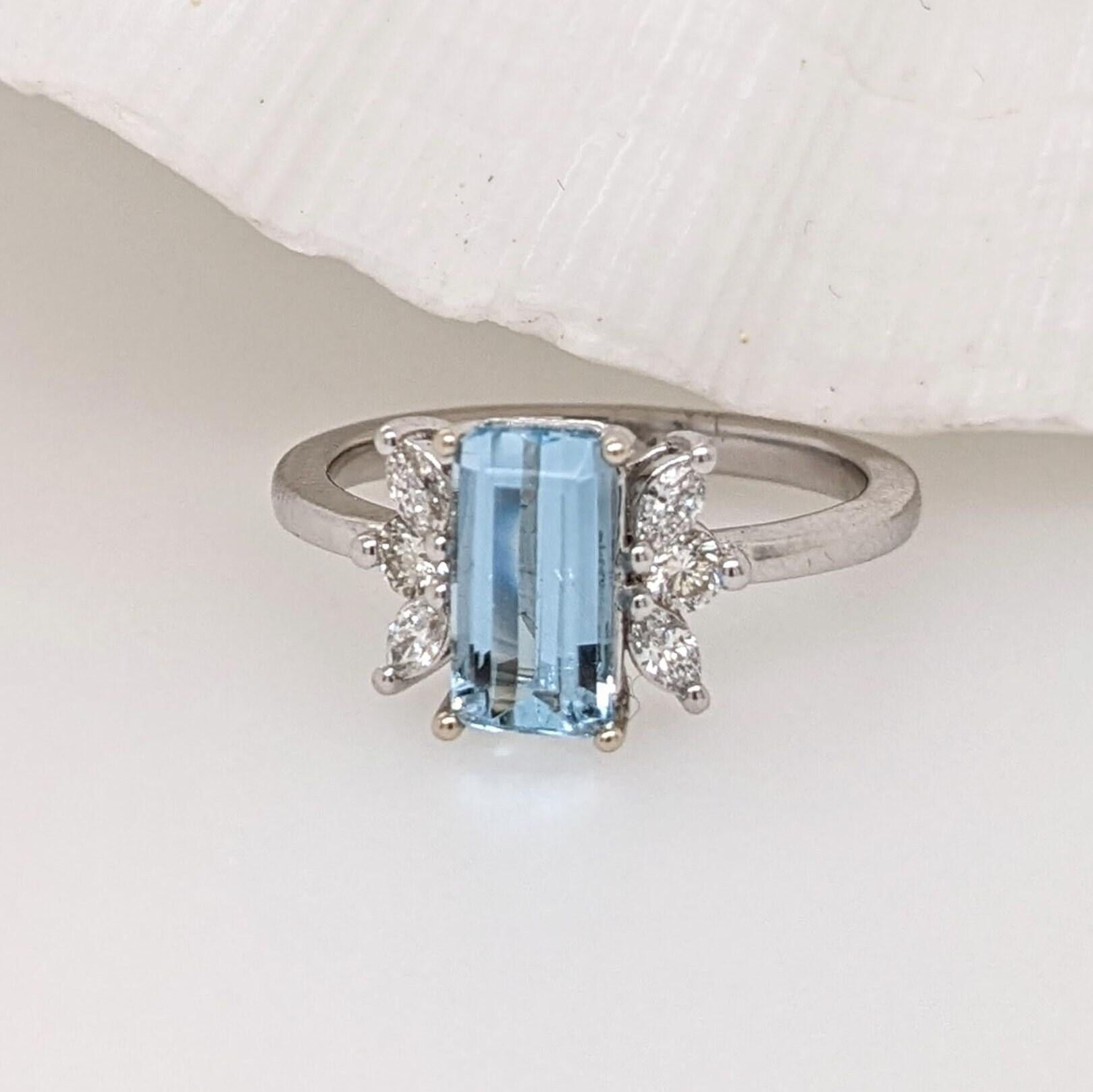 This beautiful ring features an emerald cut sparkling Aquamarine in 14k white gold with a lovely halo of natural diamonds. A statement ring design perfect for an eye catching engagement or anniversary. This ring also makes a beautiful birthstone