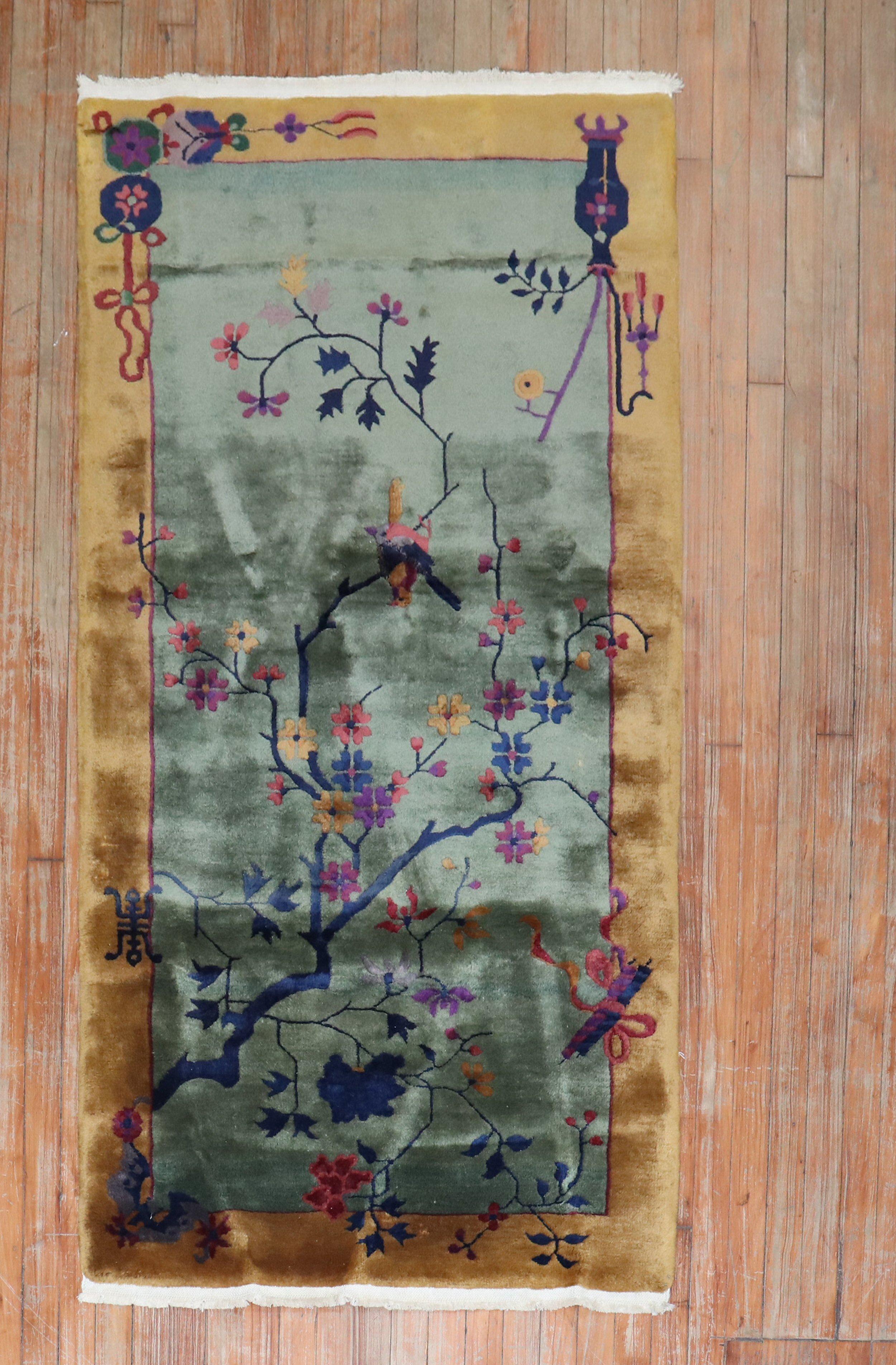 An authentic mid-20th century full Pile Chinese Art Deco wool rug with a spacious open field floral design on a pea green ground.

Measures: 3' x 6'.