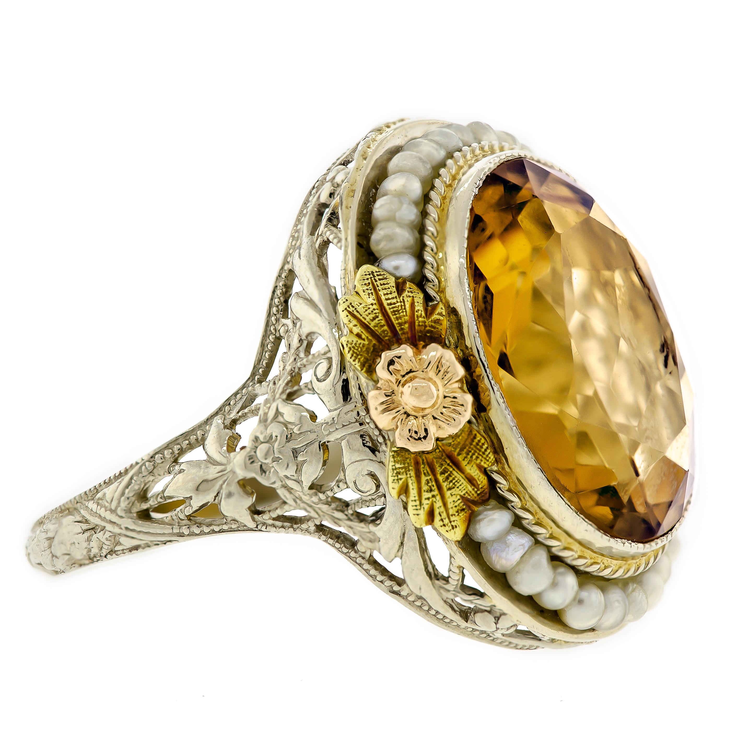 Lovely Art Deco citrine seed pearl and 14 karat white and yellow gold filigree ring centrally set with one oval brilliant cut citrine surrounded by seed pearls frame held in an elaborate 14k white gold filigree frame with applied 14k yellow gold