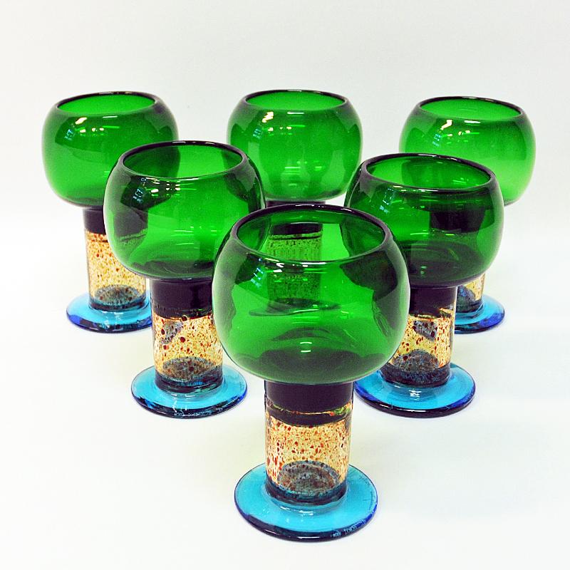 A perfect colorful pocal shaped goblet art glass designed by Kaj Franck for Nuutajärvi, Finland. These glasses were produced from 1968-1971 and have a great combination of green, blue, red and clear color. Sold as pieces. Signed by Kaj Franck.
