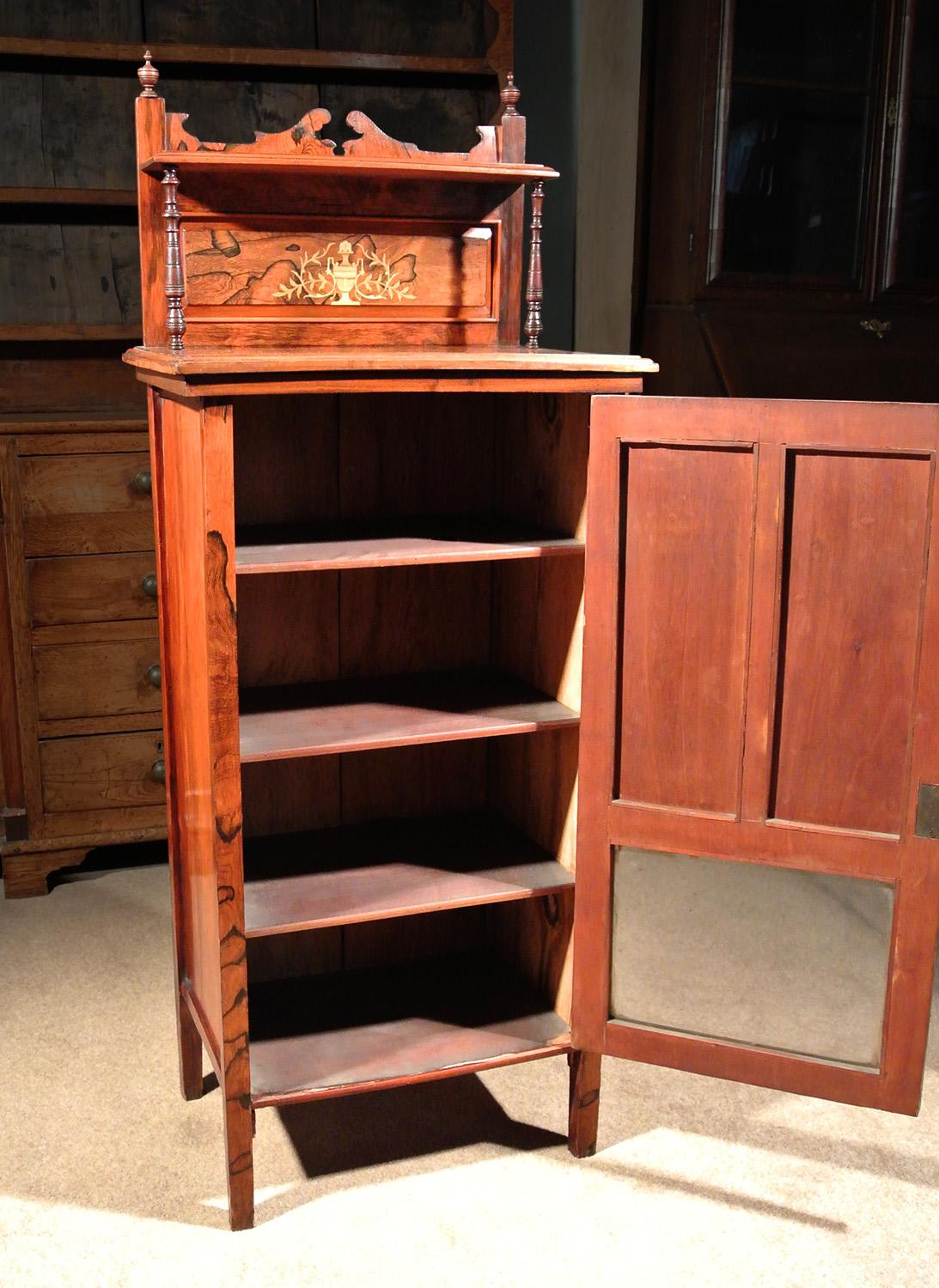 A fine quality and very attractive music cabinet in rosewood with original shelving and glass panel.

Very sturdy with no damage or repairs, the door opens smoothly and closes properly with a working key to reveal original shelves.

With the