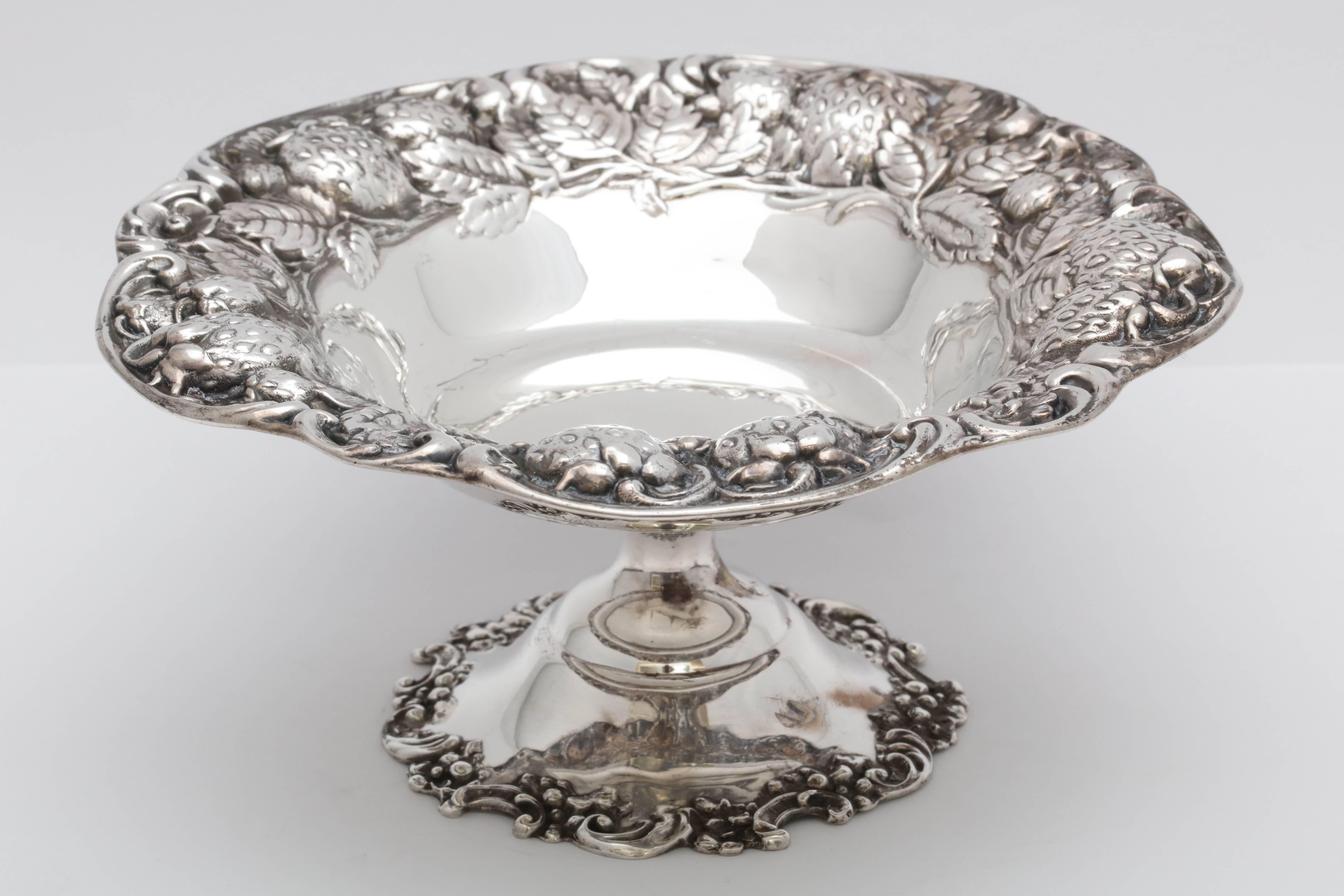 Lovely, Art Nouveau, sterling silver, strawberry compote dish on pedestal base, Mauser Mfg. Co., New York, circa 1895-1910. Designed with blown out strawberries and leaves along upper edge. Measures 3 inches high x 6 1/2 inches in diameter. Weighs