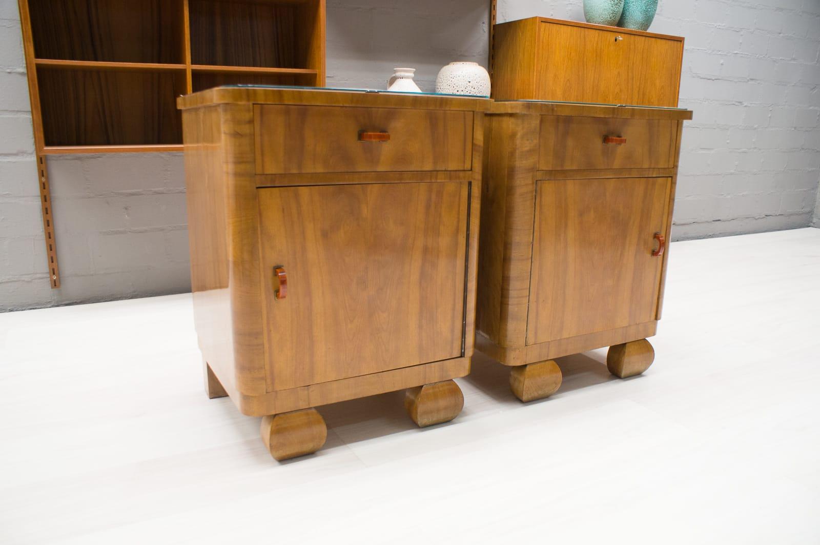 Very nice Art Deco bedside tables. 
One has a small stress crack at the side, nothing tragic, rather charming. 
Great bakalite handles.