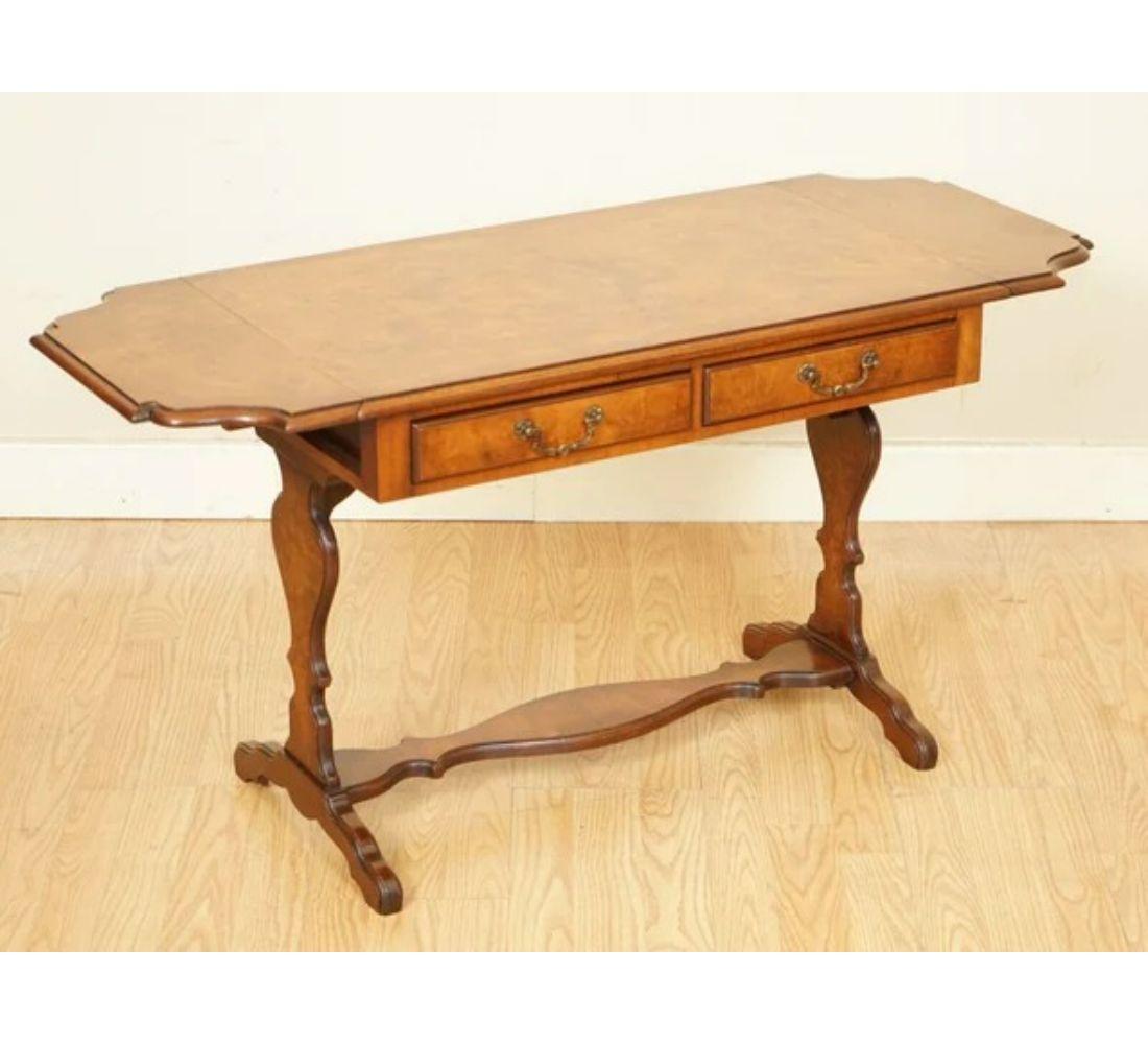 We are delighted to offer for sale this gorgeous burr walnut side end table by Bevan Funnell.

It has lovely burrs all over the piece. It features two drawers and two leaves on each side that can be extended if you like.

We have lightly