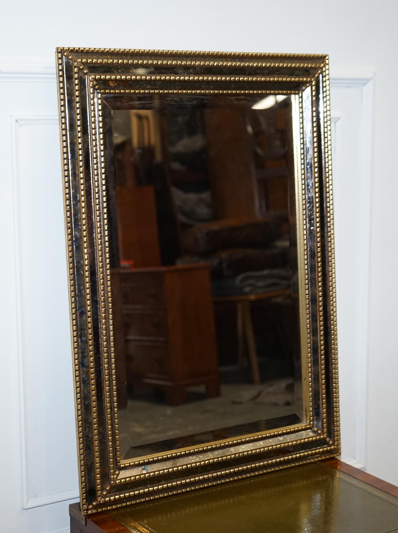 
We are delighted to offer for sale this Lovely Bevelled Triple Gold Bead Decoration Foxing Effect.

A truly stunning mirror, between the bead decoration the mirror features a foxing effect which makes the mirror have character and beauty. 

Please
