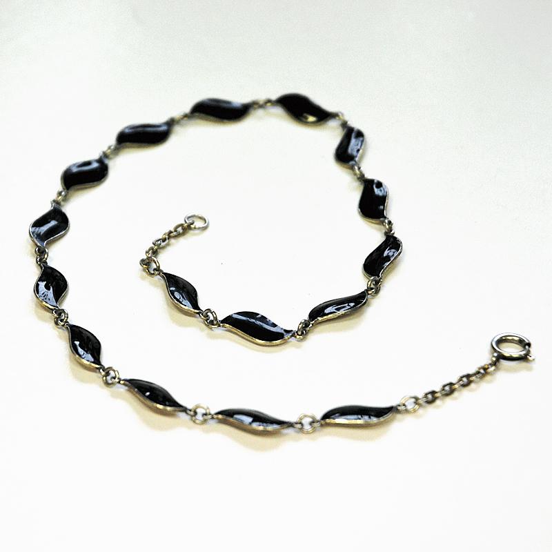 Black and lovely guilloche enameled necklace designed by Aksel Holmsen for David Andersen in the 1950s. Norway. Perfect as both a party, and everyday necklace. Extra chain length clasp to either shorten or extend the necklace.
Measures: Approximate