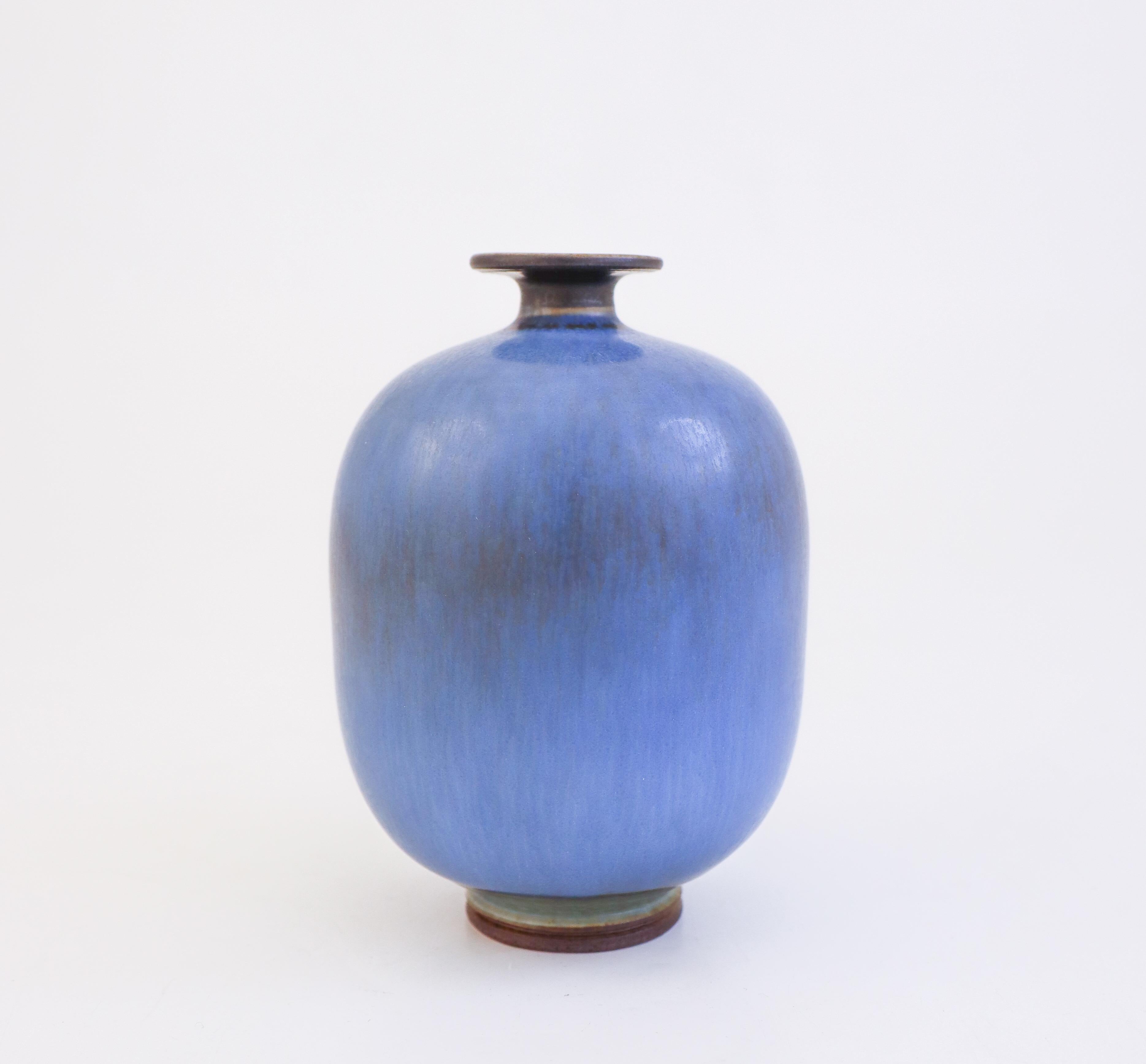 A blue vase designed by Berndt Friberg at Gustavsberg in Stockholm, the vase is 12 cm tall and about 9 cm in diameter. It has a beautiful blue glaze, it is marked as on picture and was produced in 1976, It is in mint condition.