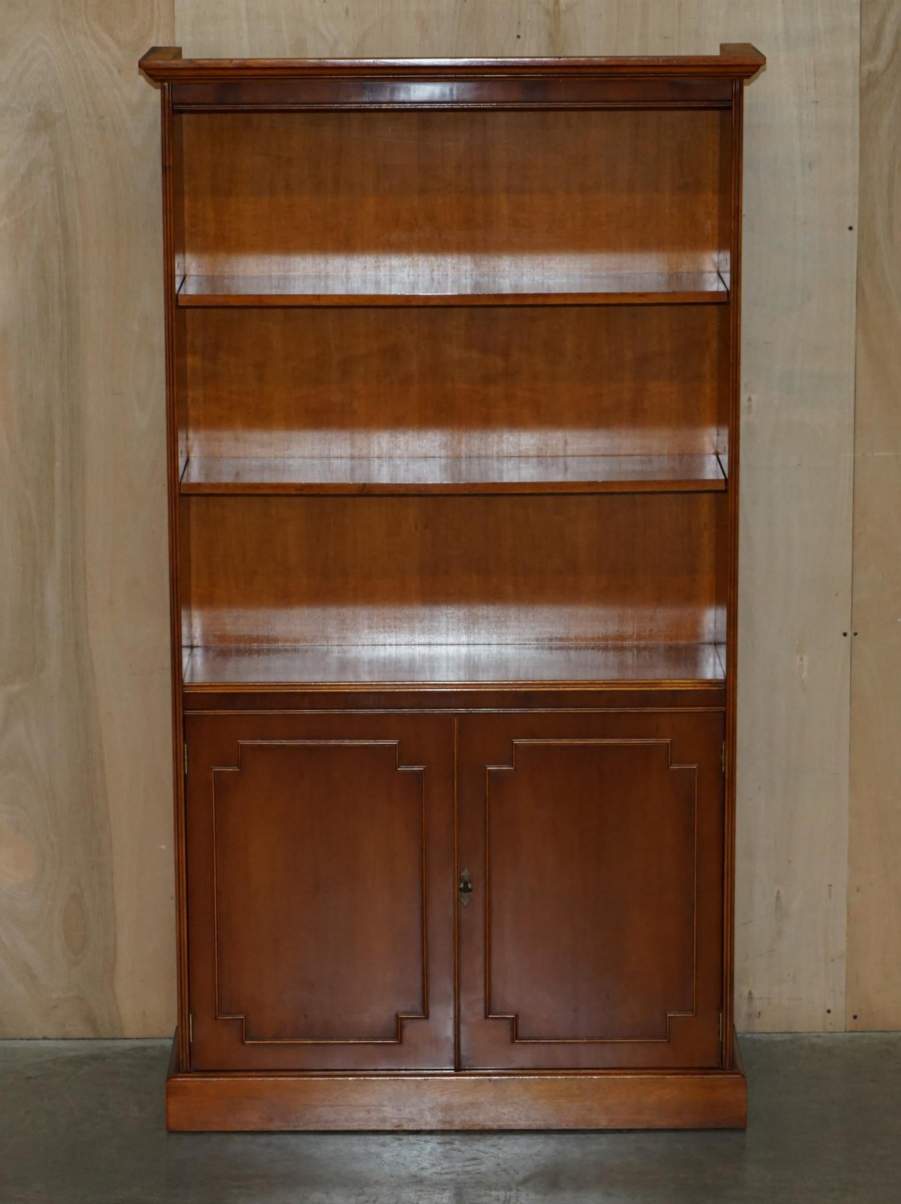 We are delighted to offer for this lovely vintage Bradley Furniture England Yew wood & Brass Military Campaign open library bookcase with cupboard base

A very good looking well made and decorative piece, it is very rare to find this bookcase in