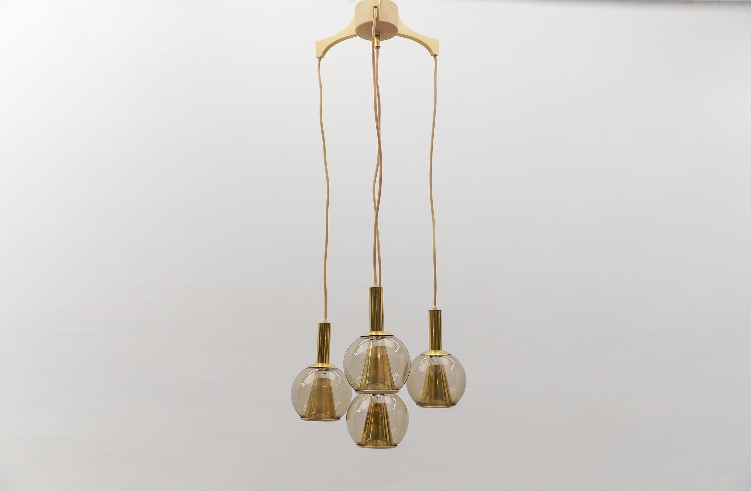 Lovely Brass and Smoked Glass Mid-Century Modern Cascading Lamp, 1960s Germany

Fully functional. 

Four E14 sockets. Works with 220V and 110V.

Our lamps are checked, cleaned and are suitable for use in the USA.