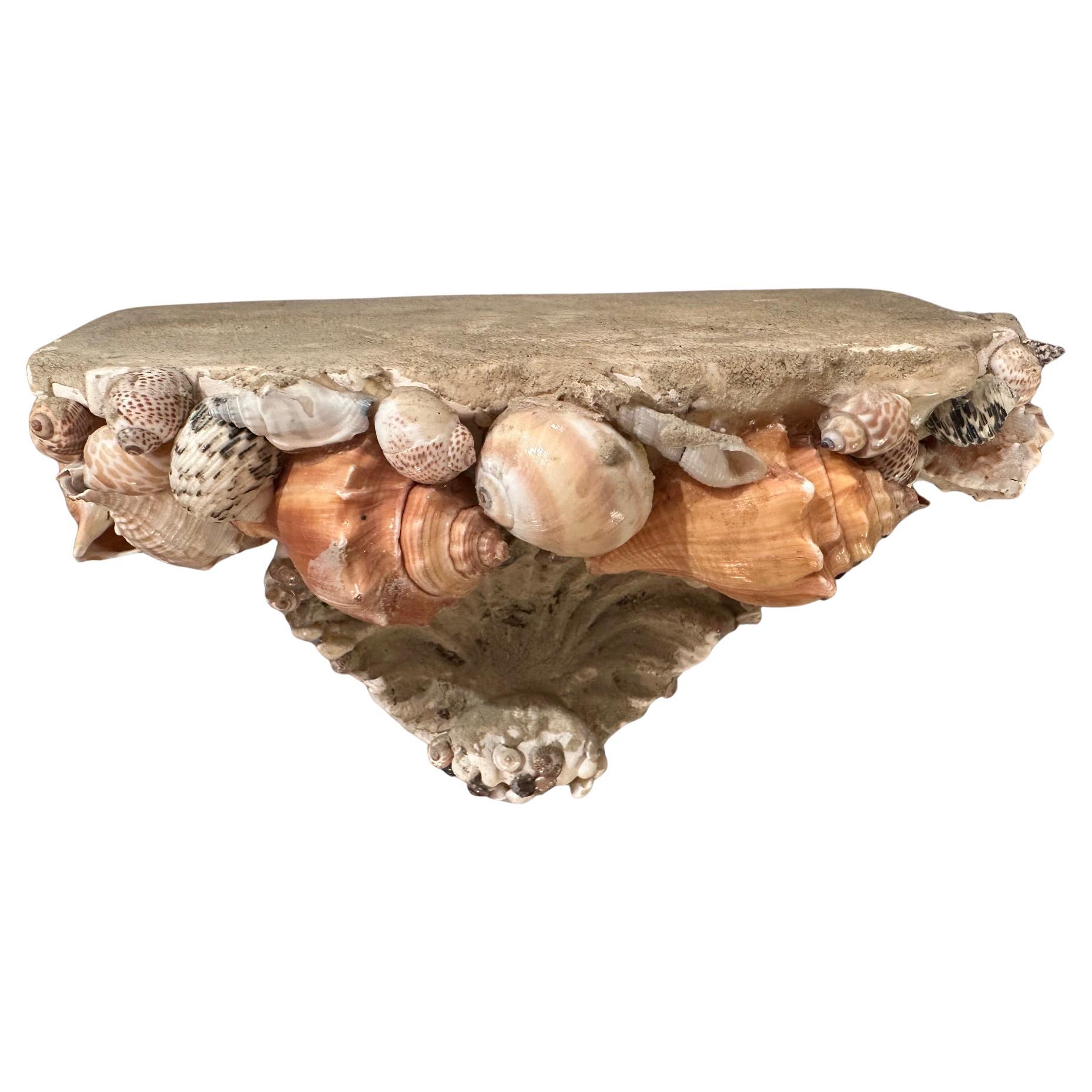 
Vintage cast stone wall bracket adorned with natural seashells. 


