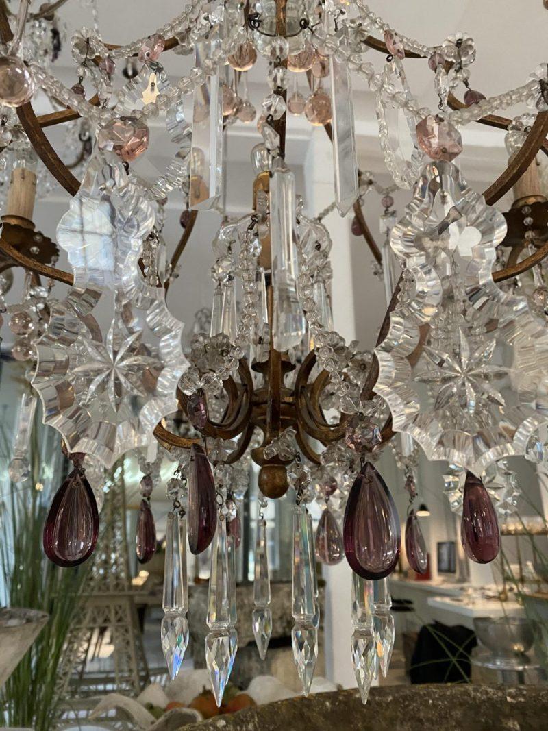 Handsome old framed chandelier in brass, from France circa 1900, with varying sizes of elegant leaf-shaped faceted prisms.

Beautifully decorated with violet grape-shaped prisms, and 7 light pipes that make the light reflect in a magical way via the