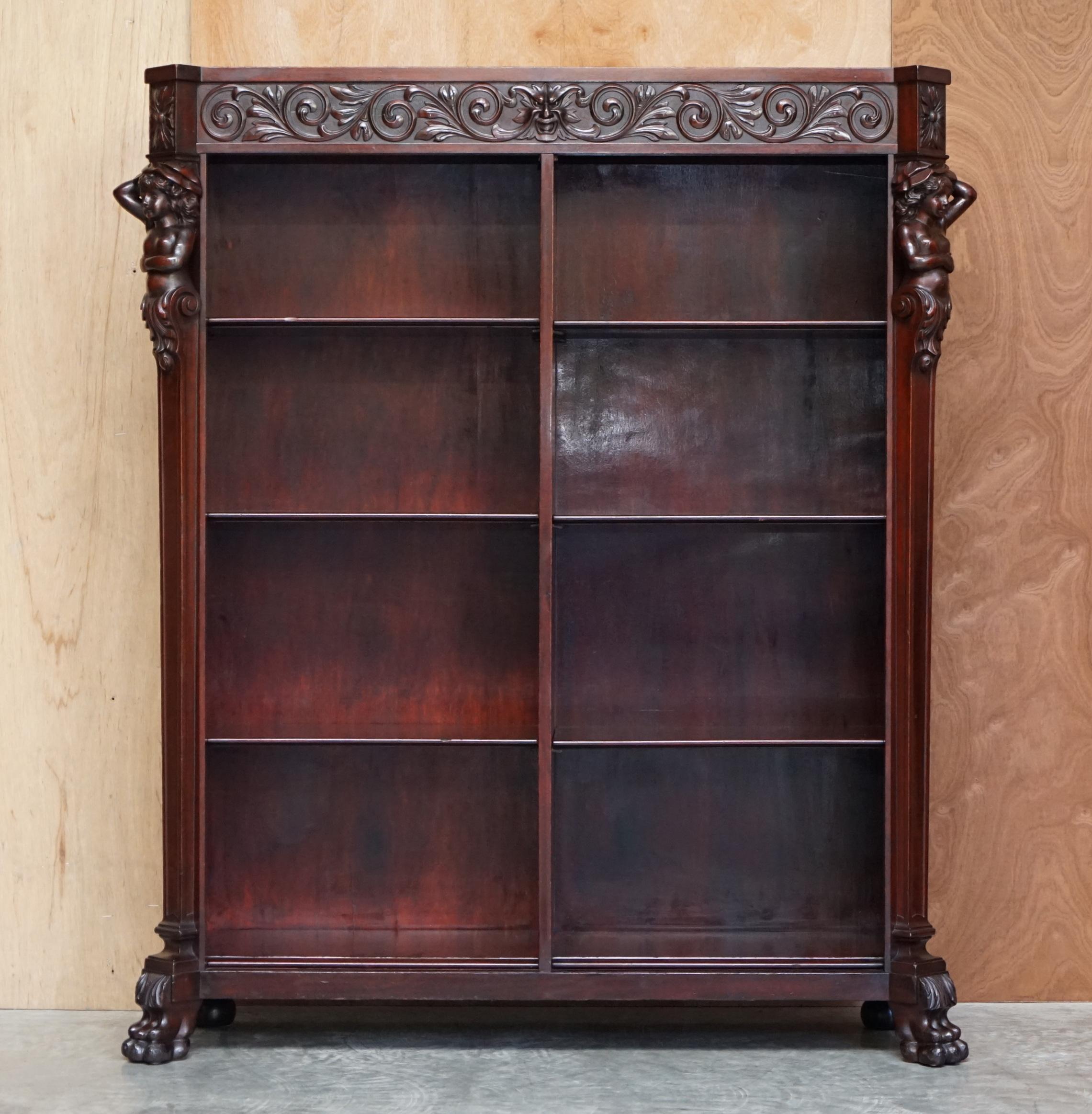 We are delighted to offer this stunning original mahogany library bookcase with herm carved statues and Lion hairy paw feet to the base

A good looking and well made piece, its rare to find one with the ornately carved Herm statues on the sides,