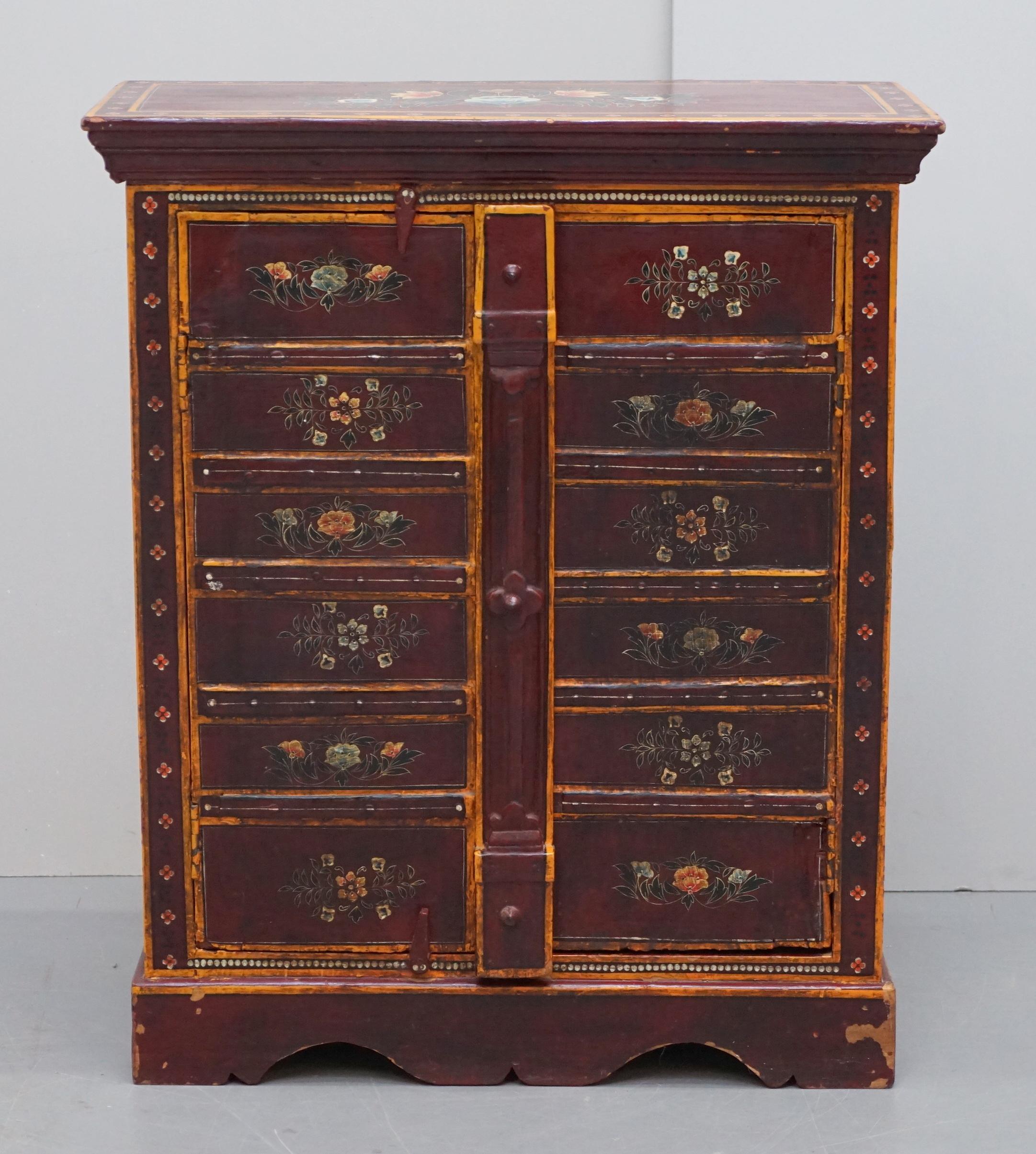 We are delighted to offer for sale this lovely circa 1900 eastern hand painted with floral details side pot cupboard with original metal strapwork door supports

A very well made and decorative piece, circa 1900 and from the far east, these pieces