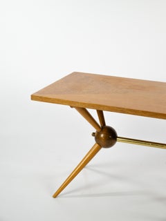 Lovely coffee table in clear and dark wood with sputnik style feet