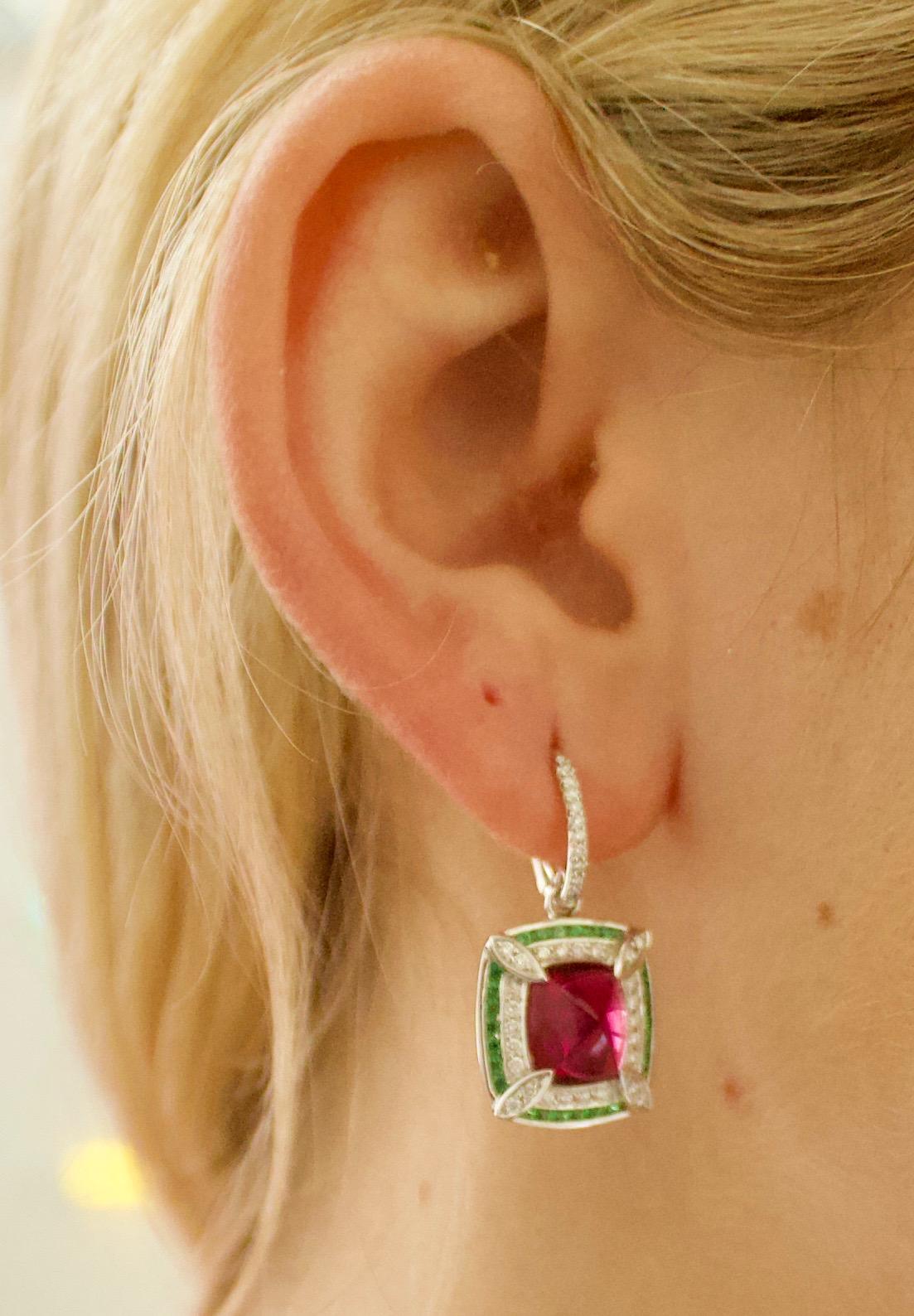 Lovely Dangling Rubellite  & Tsavorite Garnet & Diamond Earrings in 18k Gold
Two Sugar Loaf Cut Rubellites Weighing 4.60 carats
Fifty Seven Round Brilliant Cut Tsavorite Garnets Weighing.53 carats
Seventy Twi Round Brilliant Cut Diamonds Weighing