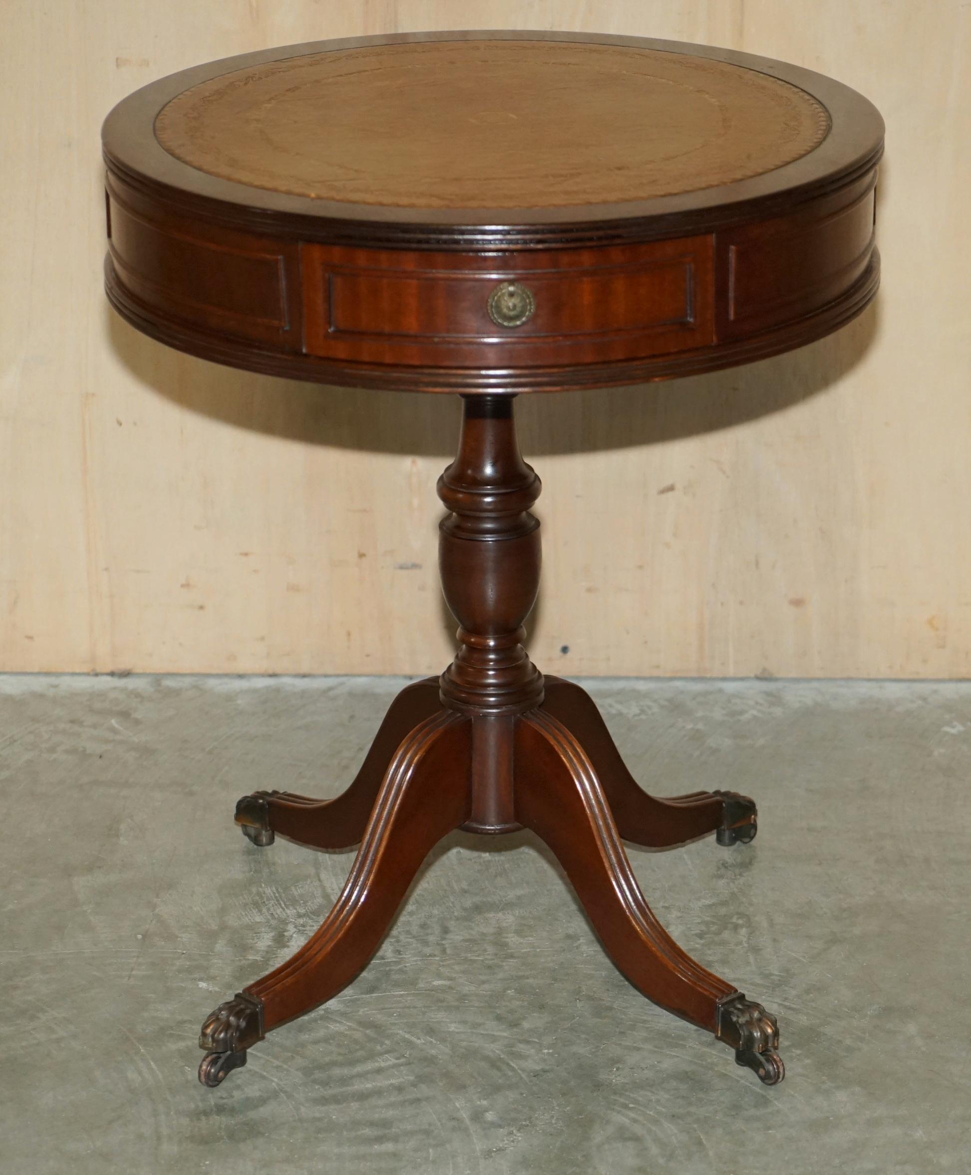We are delighted to offer for sale this Regency style drum table with beech wood frame and hand dyed green leather top with gold leaf tooling and twin drawers

A very good looking well made and decorative piece, ideally suited as a lamp wine or