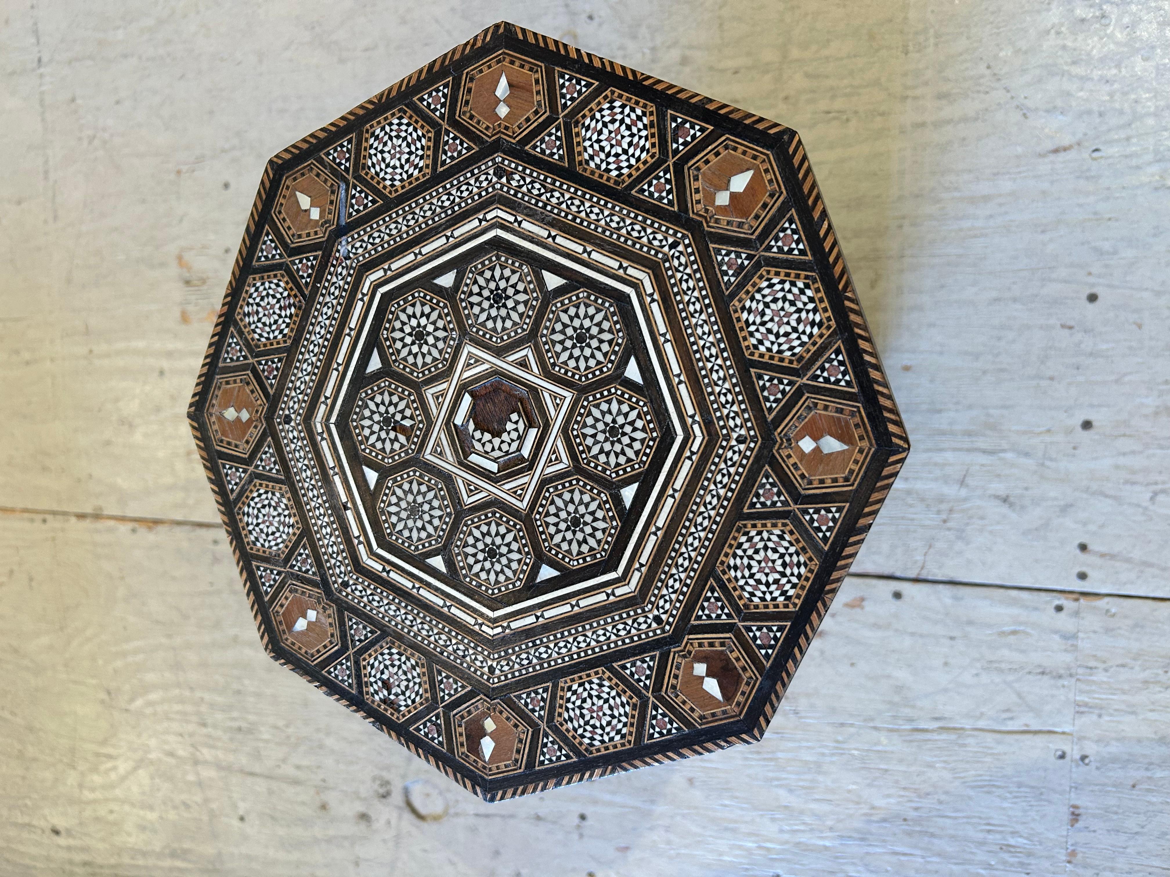 Charming small octagonal drinks table intricately inlaid with mixed woods and bone.