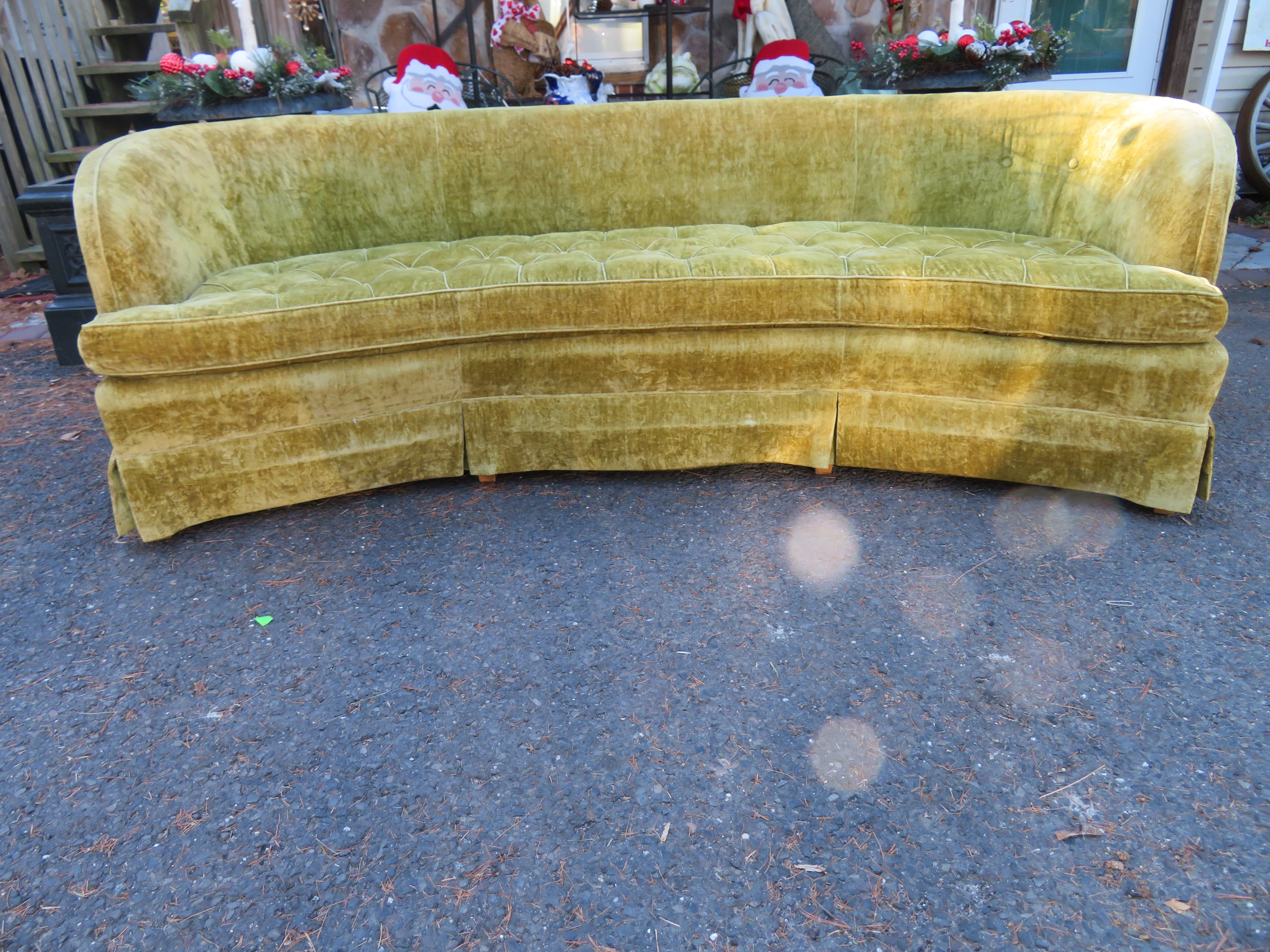 Classic Hollywood Regency Dorothy Draper for Heritage curved sofa. A wonderful curvaceous back with tufted cushioning and a curtained front bottom edge. This sofa retains its original velvet fabric and is in need of being reupholstered. The frame is