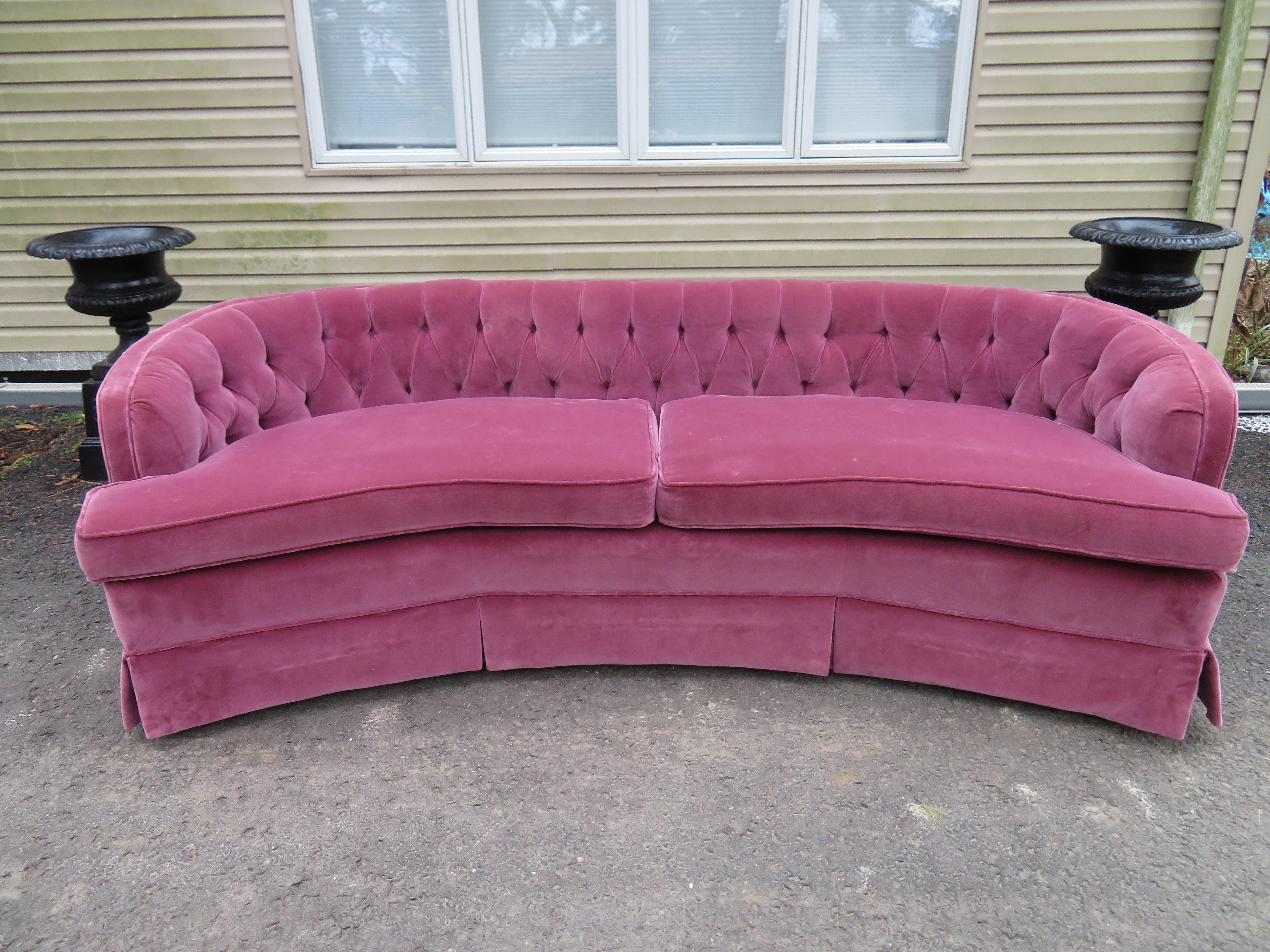 Lovely Dorothy Draper style Lilac velvet curved tufted sofa. This piece is a real beauty as is with just some light wear to original lavender velvet. This sofa measures: 28