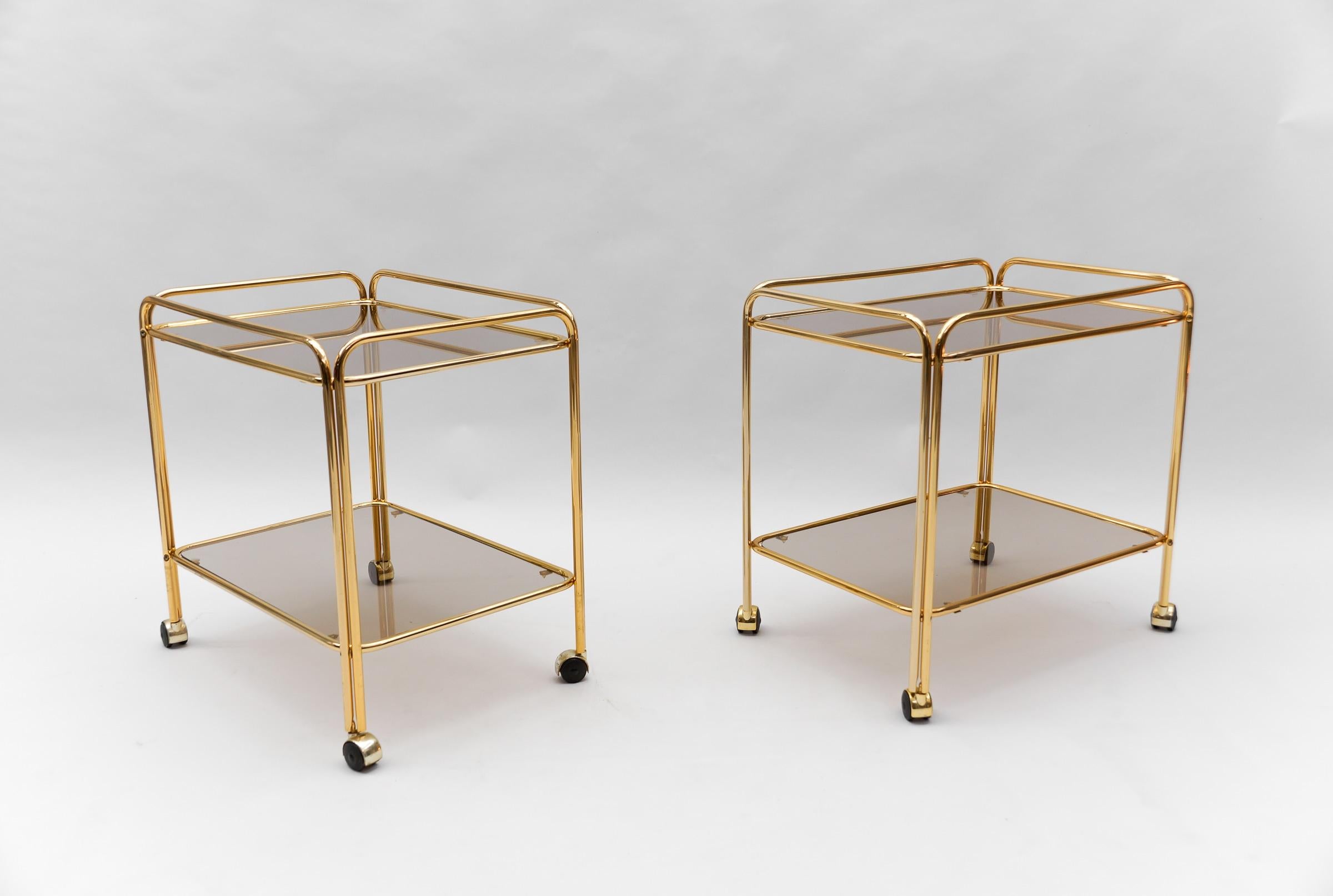 Beautiful faux bamboo serving table in heavy brass with smoked grey glass plates by Maison Baguès Paris.
Maison Baguès is renowned for fine brass objects and lights since its establishment in 1860.
The idiosyncratic genius Armand-Albert Rateau used