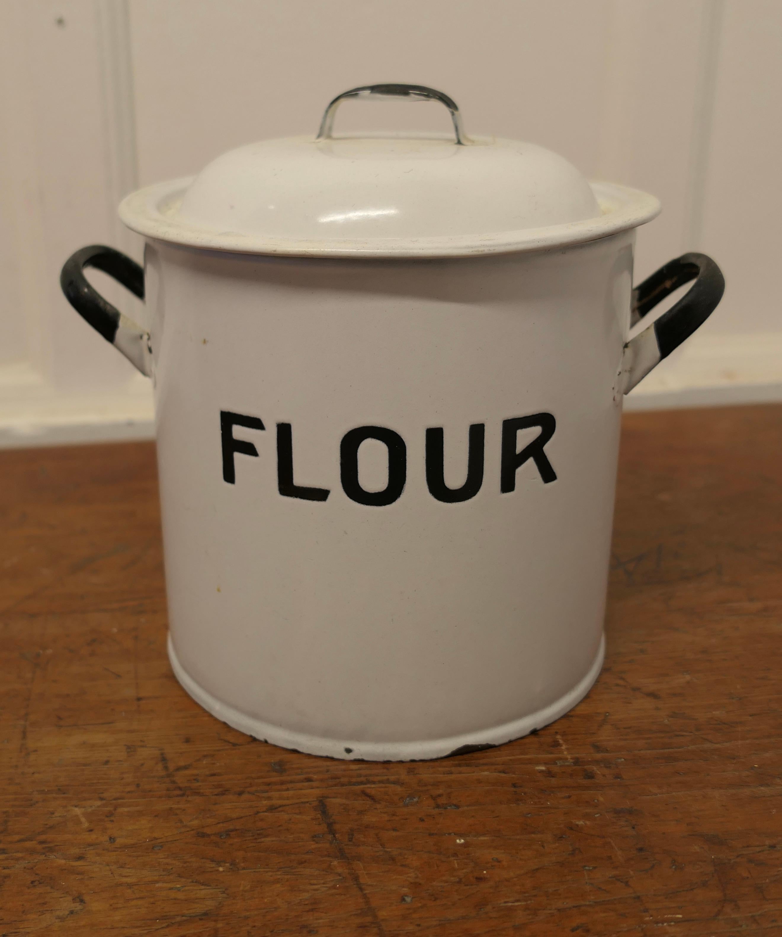 Lovely Enamel Flour Food Canister 

Original Enamel Flour Bin with handles and cover lid, the canister has Black lettering it is in very good condition with very minor dings
The Bin is 9” high has 11” in diameter including the handles
SW201