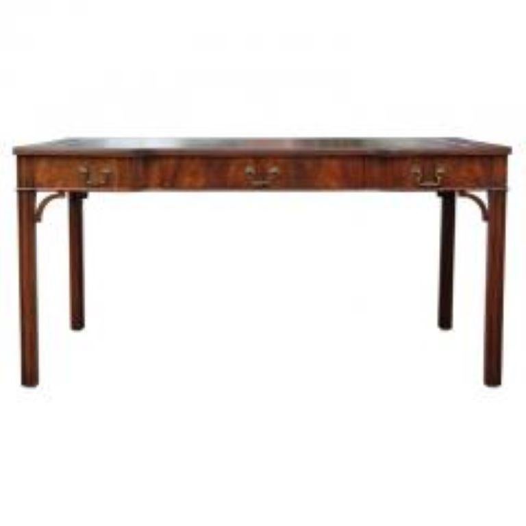 Fine Wood & Hogan English bench-made mahogany Chippendale style three drawer writing table with tooled leather shaped top and pull out slides on each end. Each fitted drawer with solid brass ornate handles. Resting on moulded legs.

This spectacular