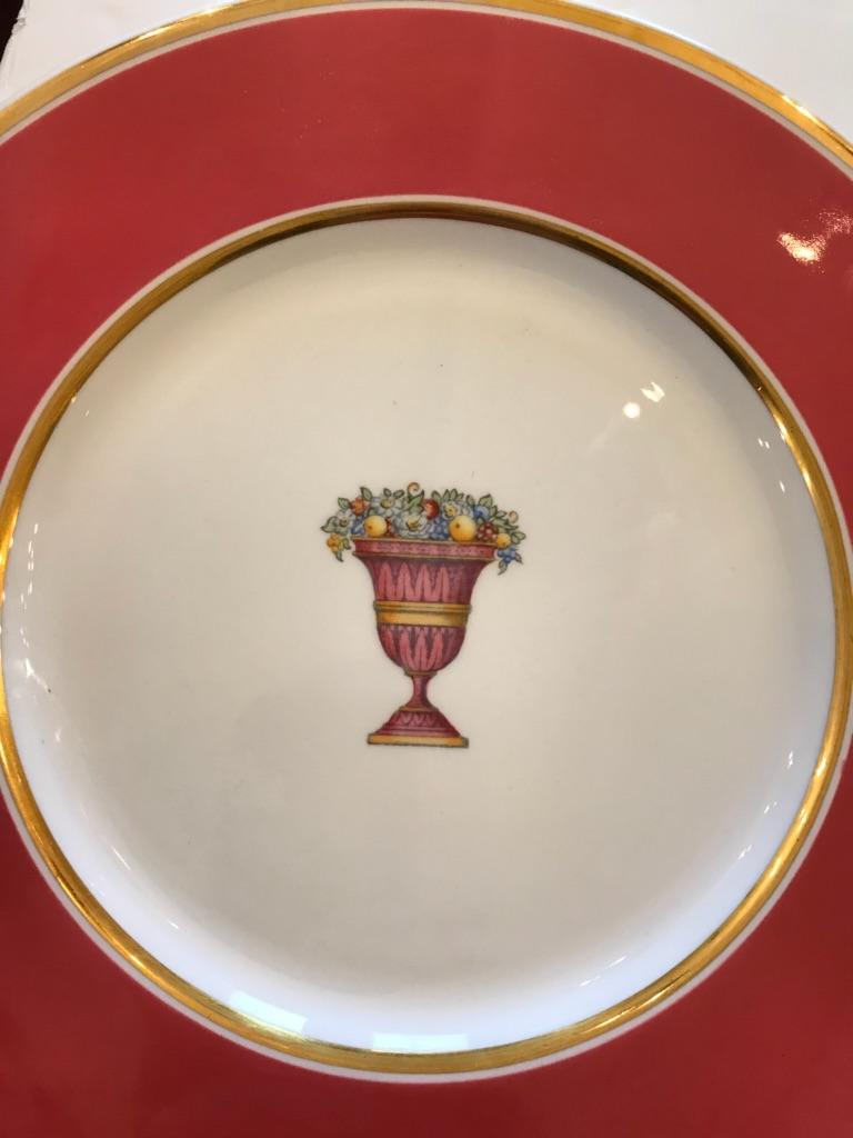 A set of 12 beautiful rouge and gold service plates having a central urn with flowers. 
Imprint on back of plates says Spode Copelands China Bailey Banks & Biddle England.