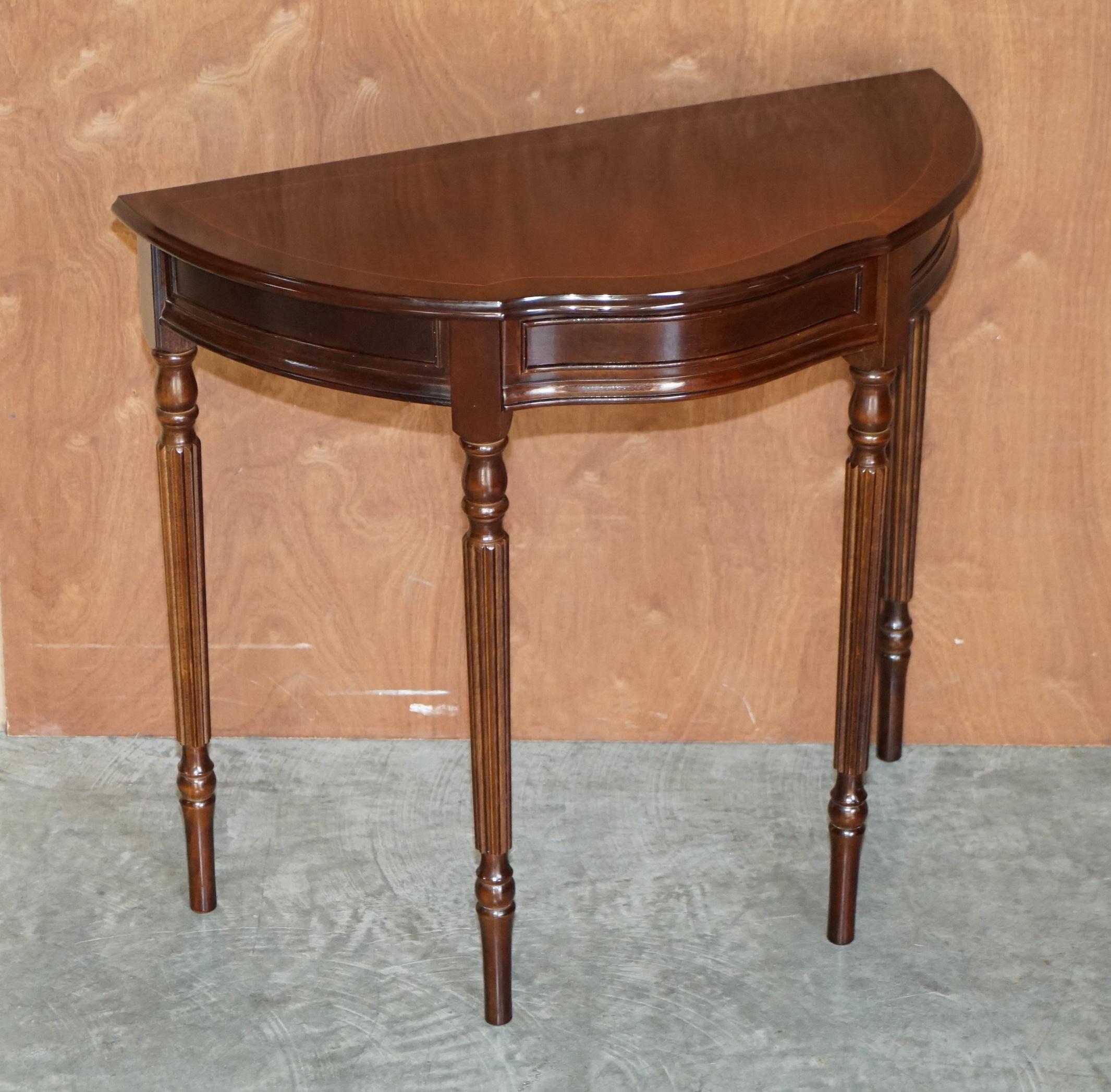 We are delighted to offer for sale this stunning vintage flamed mahogany demi lune console tables with single drawer

A good looking well made and decorative table, it has one good sized middle drawer with tapered legs

The table has been