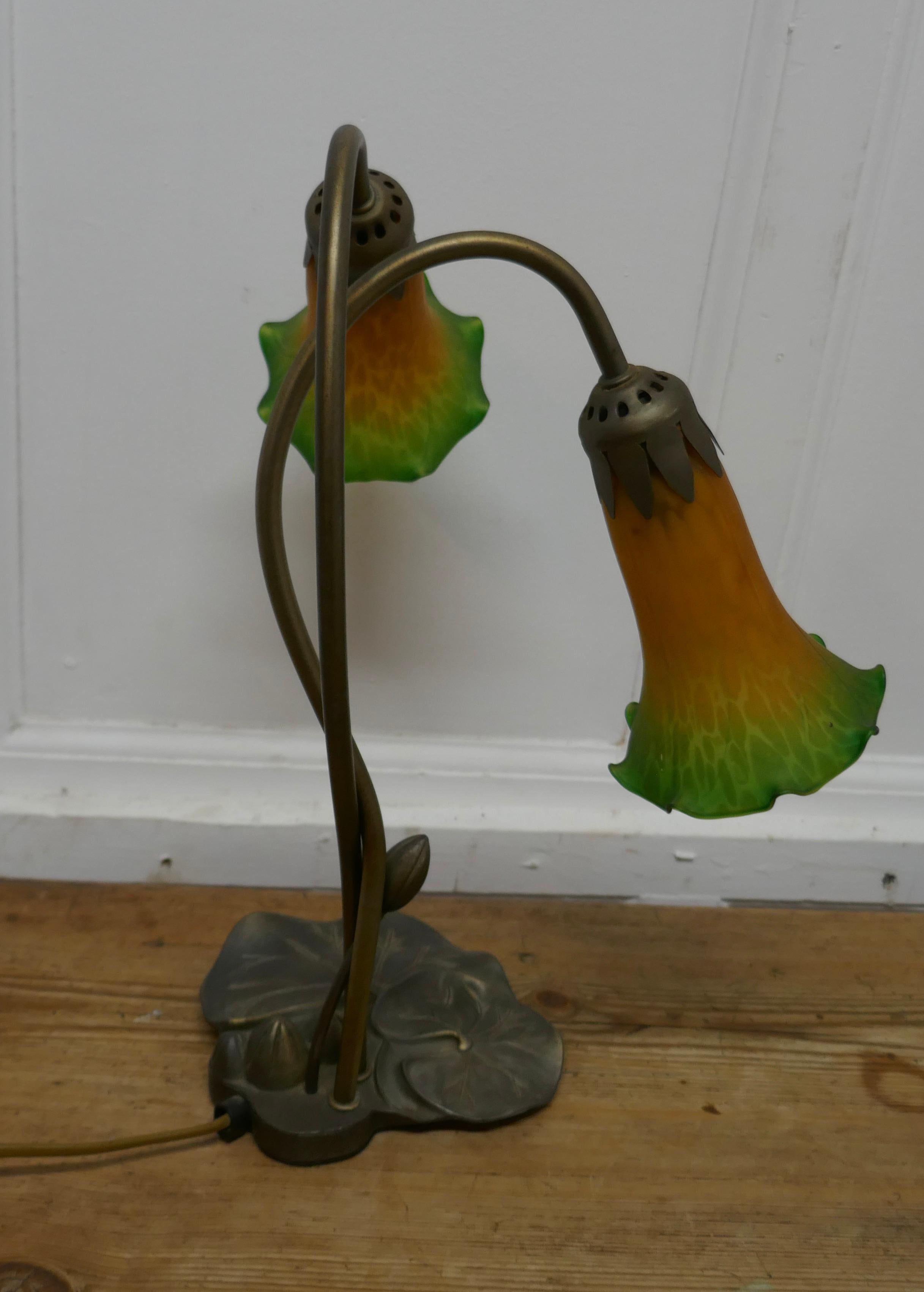Lovely French Art Nouveau style Lilly pad lamp

A lovely piece, long flower like glass shades hang from the twining stems of the water Lilly, the lamp is in dark colored brass and the shades are in amber and green glass
In good used condition