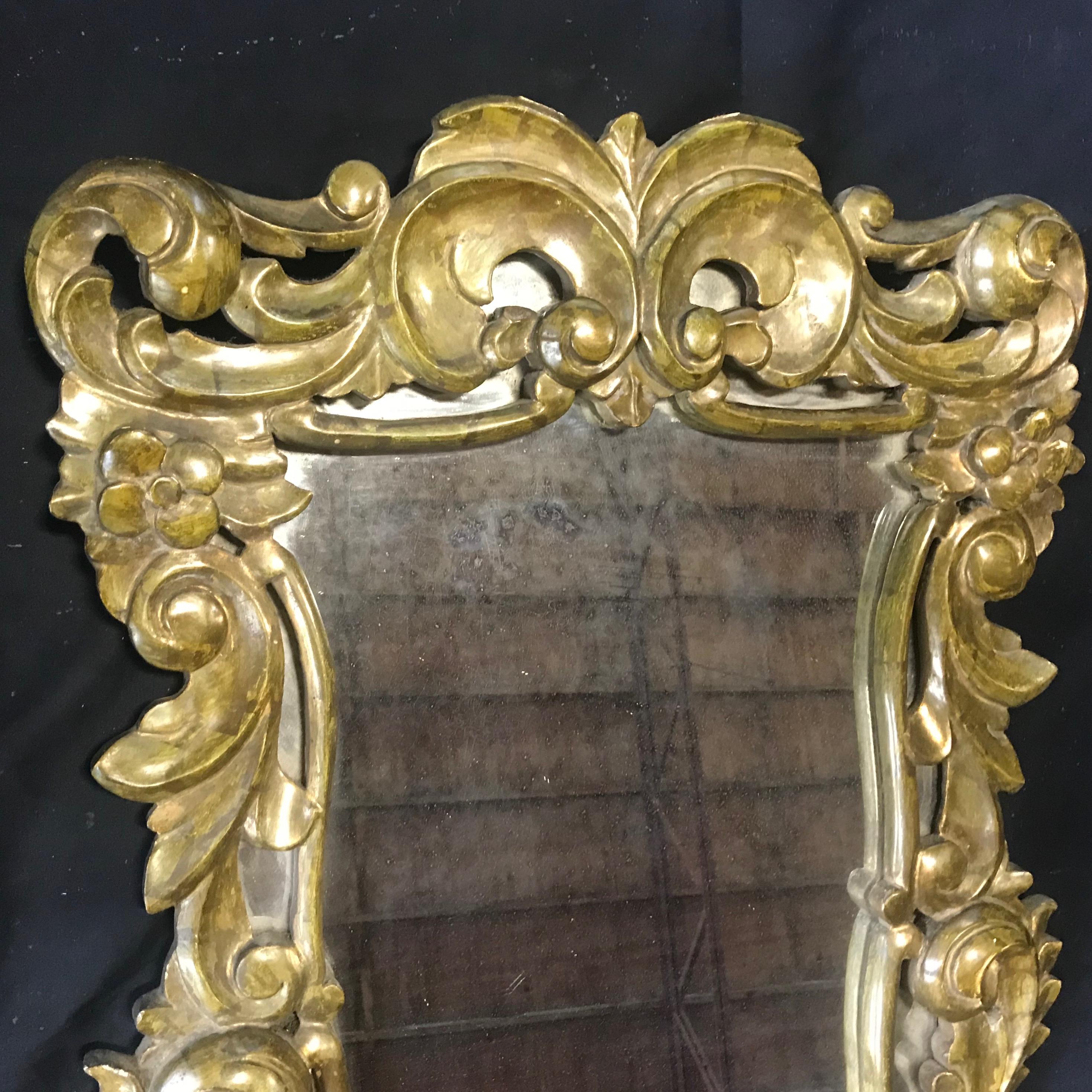 A gorgeous antique French gold pressed brass ornate wall mirror having wonderful curlicues and shape.

#3000.