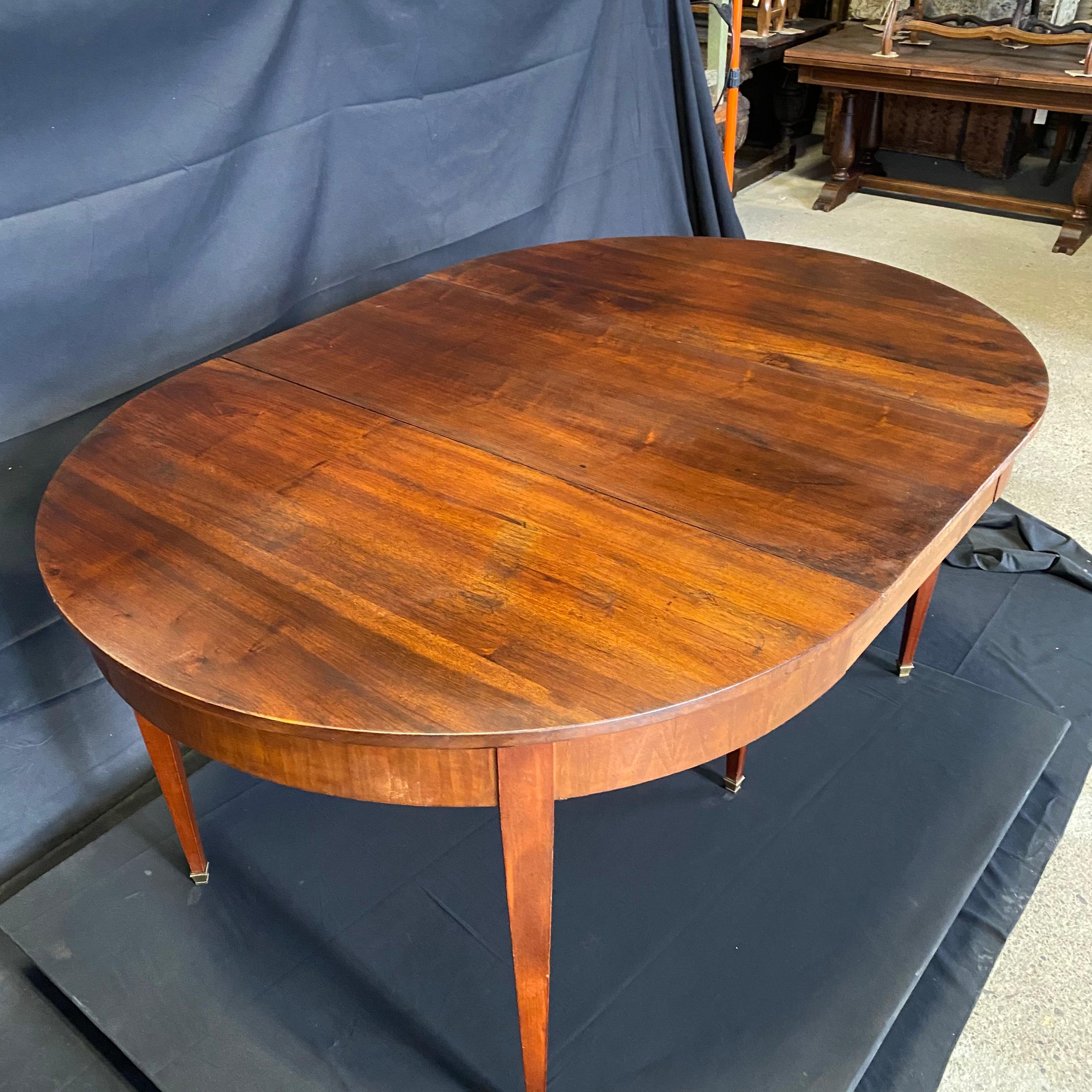 Lovely round or when expanded, oval Louis XVI table from Lyon, France could serve many uses: as an entry or statement table, as a lovely floating desk, as a smaller round dining table for 4, or expanded to a 63