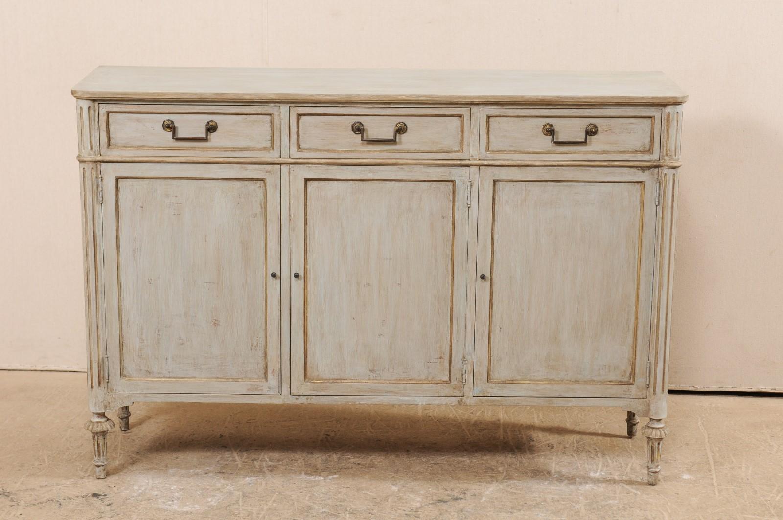 A French painted wood buffet cabinet from the mid-20th century. This vintage cabinet from France features a rectangular-shaped top which rests above three upper recessed panel drawers, and three recessed panel doors below. Flanked by front side