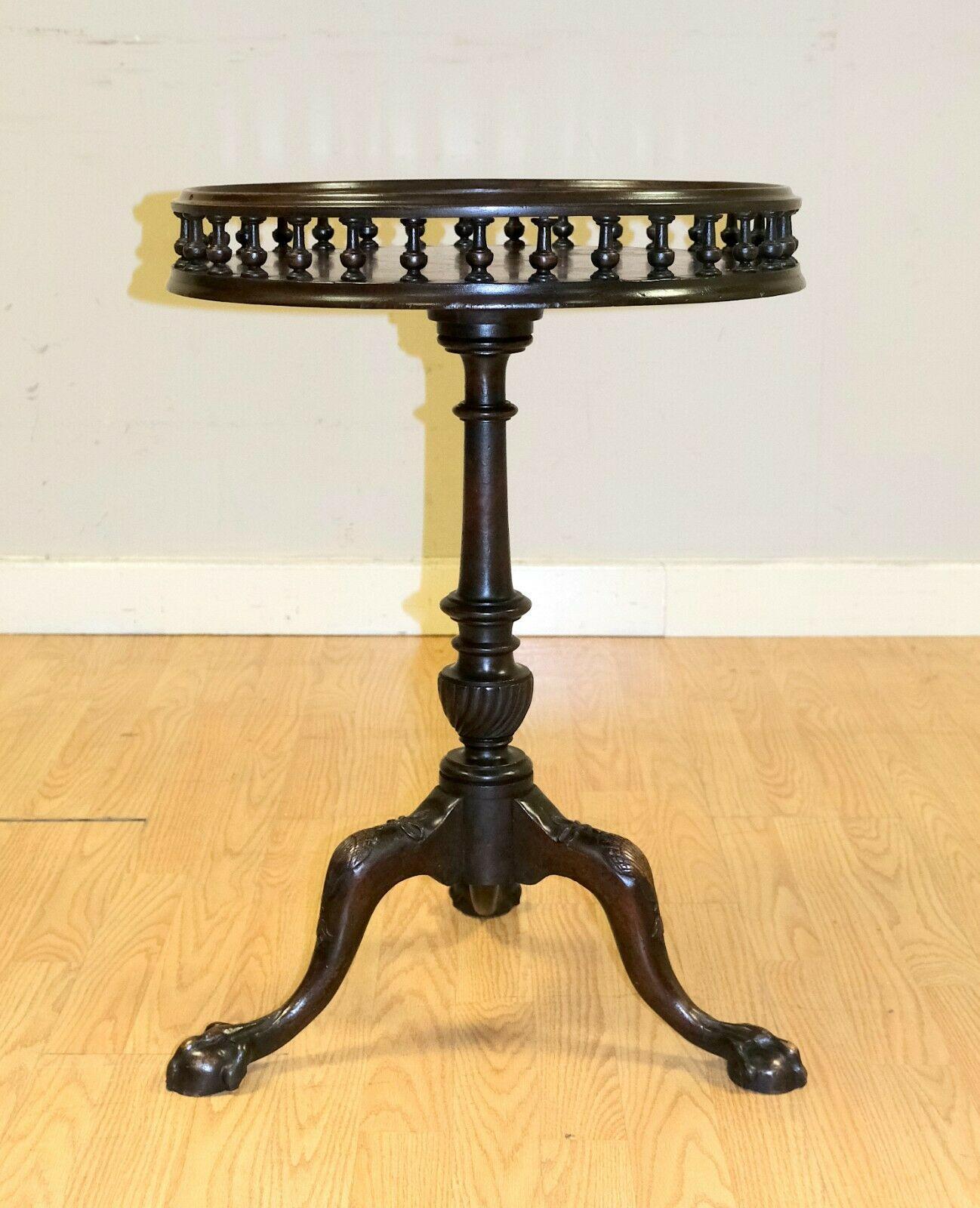 We are delighted to offer for sale this lovely Georgian style Mahogany gallery occasional/wine /side table.

This charming and attractive table is standing on tripod claw feet and beautifully carved base. On the top, shows a spindle gallery, which