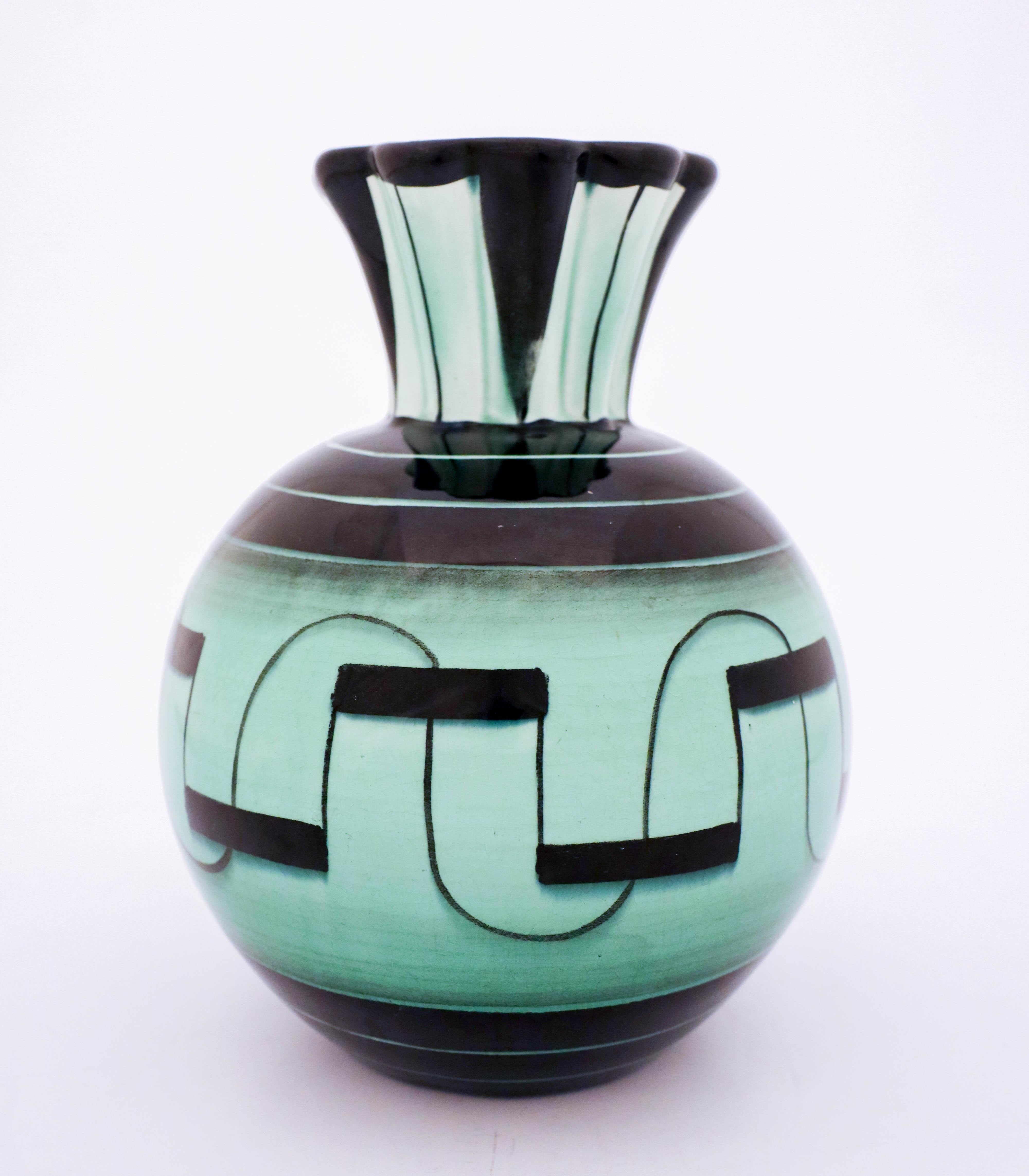 A lovely vase designed by Ilse Claesson in the 1930s at Rörstrand, Sweden. It is 22 cm high and in very good condition except from some craquelure in the glaze because of the age.