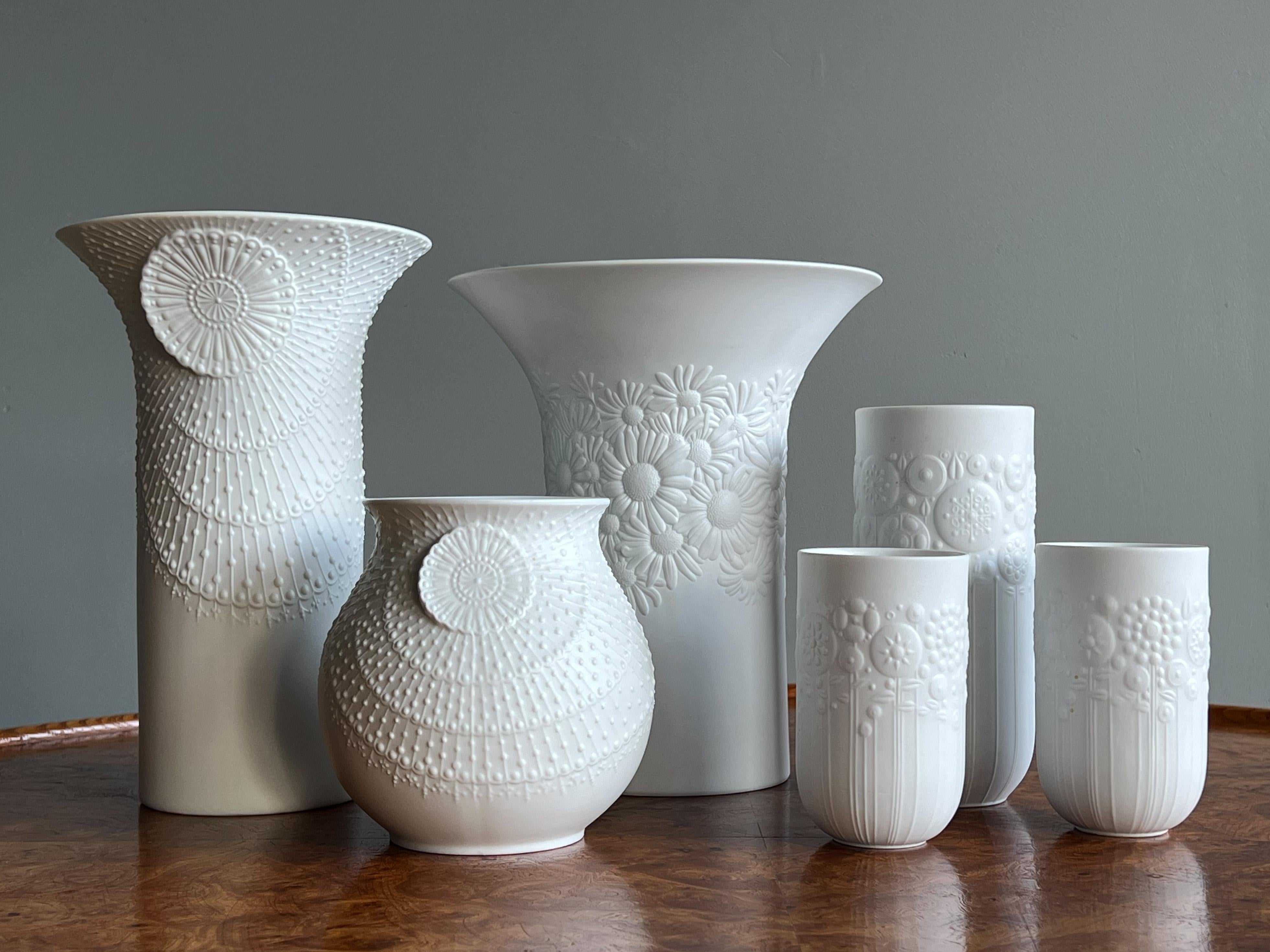 A lovely grouping of porcelain bisque vases for Kaiser Germany and Rosenthal “Studio Line” c.1970s. The decorative forms looked so good as a whole, we decided to offer them together. 

The taller vase on far left and the smaller directly under are