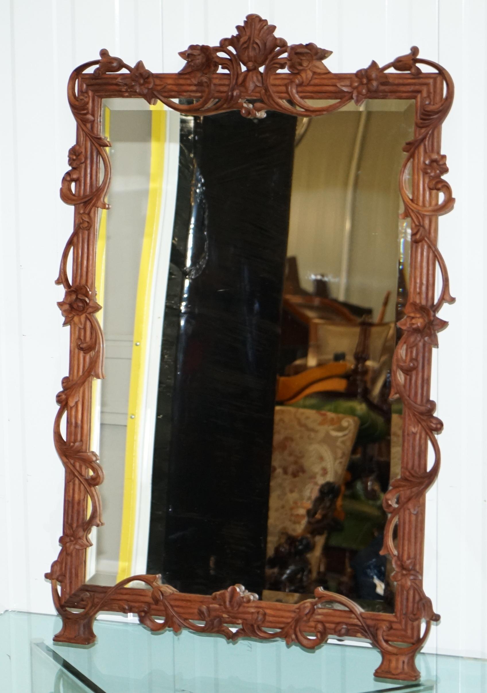Wimbledon-Furniture is delighted to offer for sale this lovely hand carved with flowers and foliage large wall mirror with bevelled glass

A well made good looking and decorative piece, nicely carved and looking lovely from all angles

The glass is