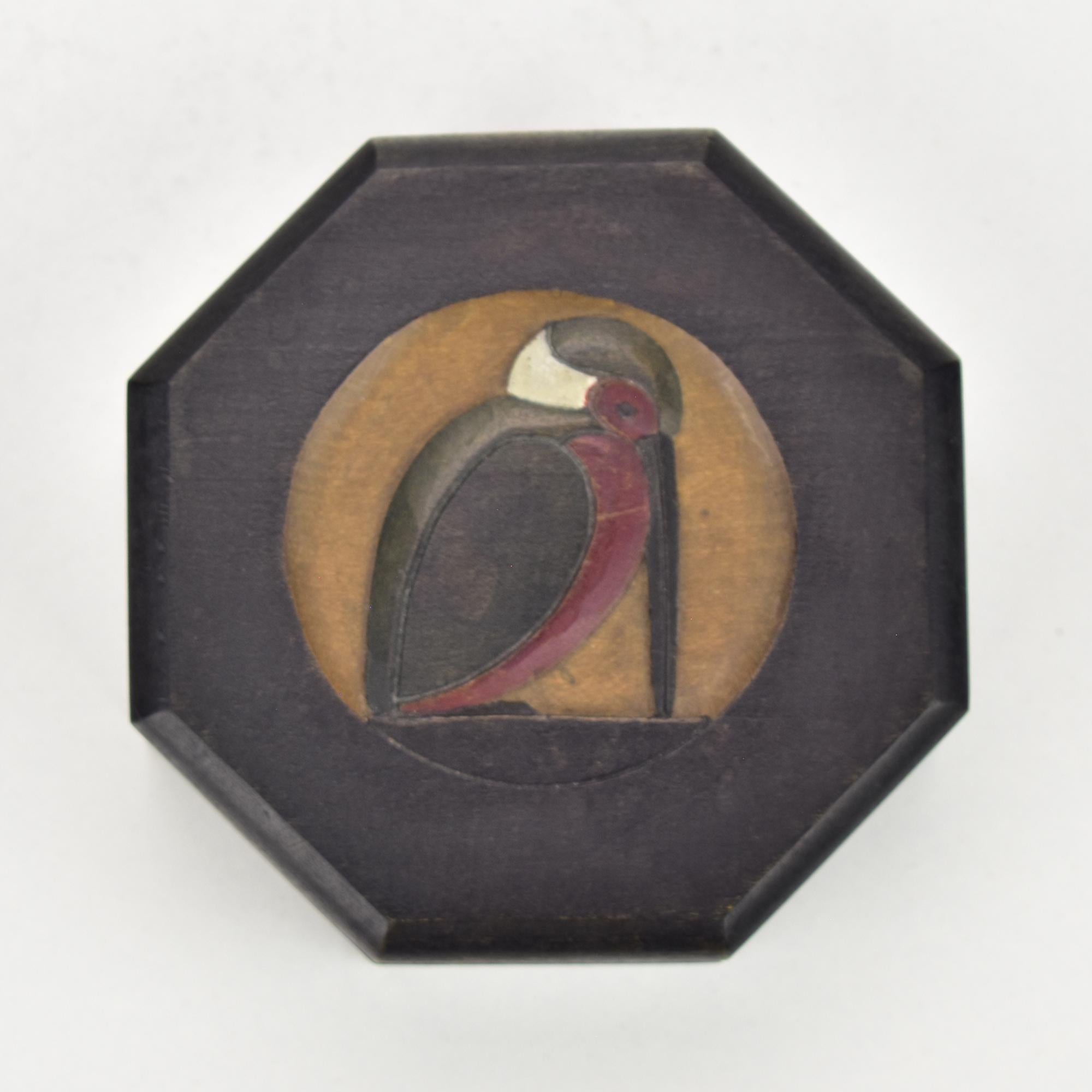 This exquisite hand-carved wooden jewelry box features a beautifully stylized depiction of a kingfisher bird. The octagonal box showcases intricate craftsmanship, with the bird motif carefully carved into the lid. 

The kingfisher, known for its